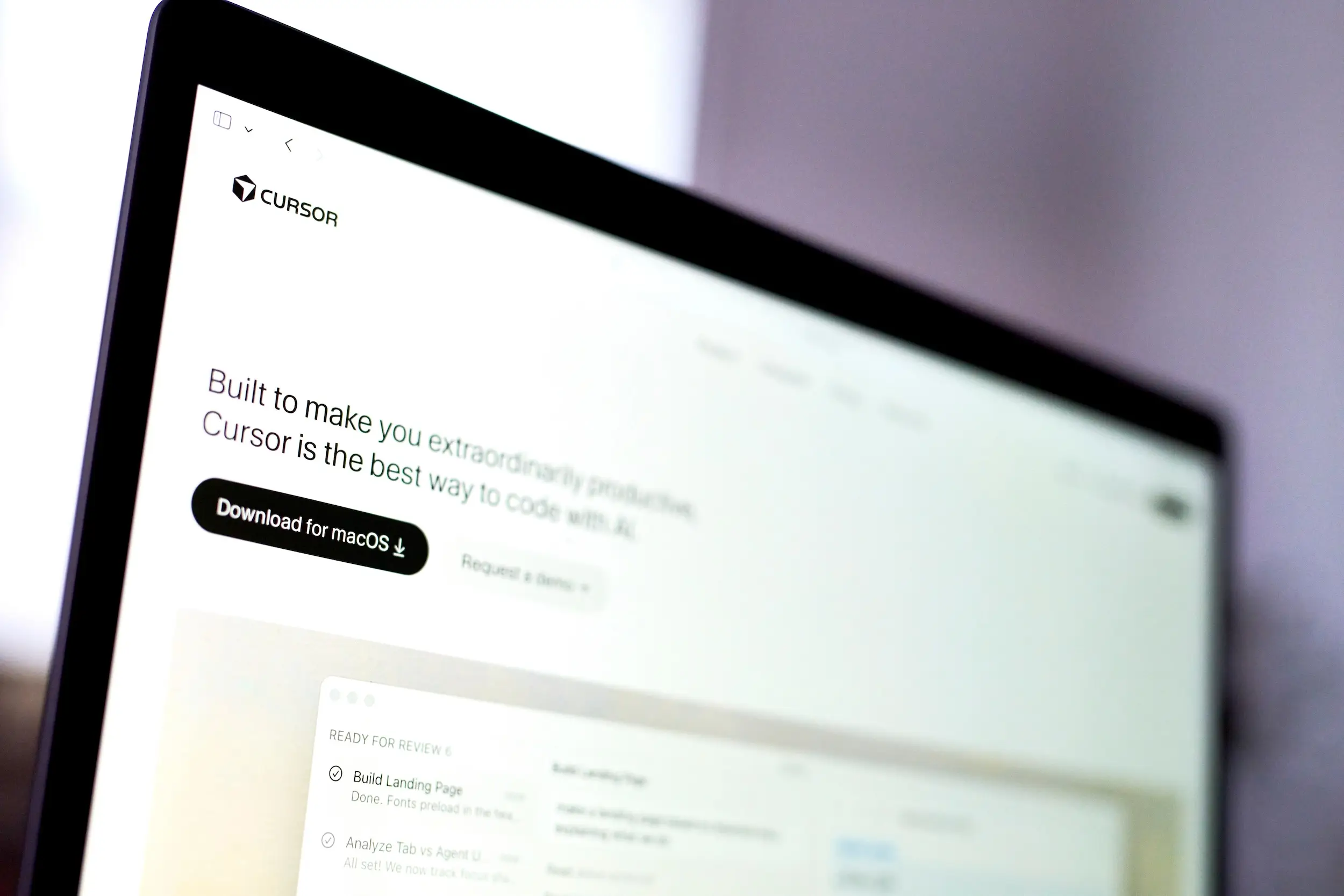 Cursor's website is seen on a laptop