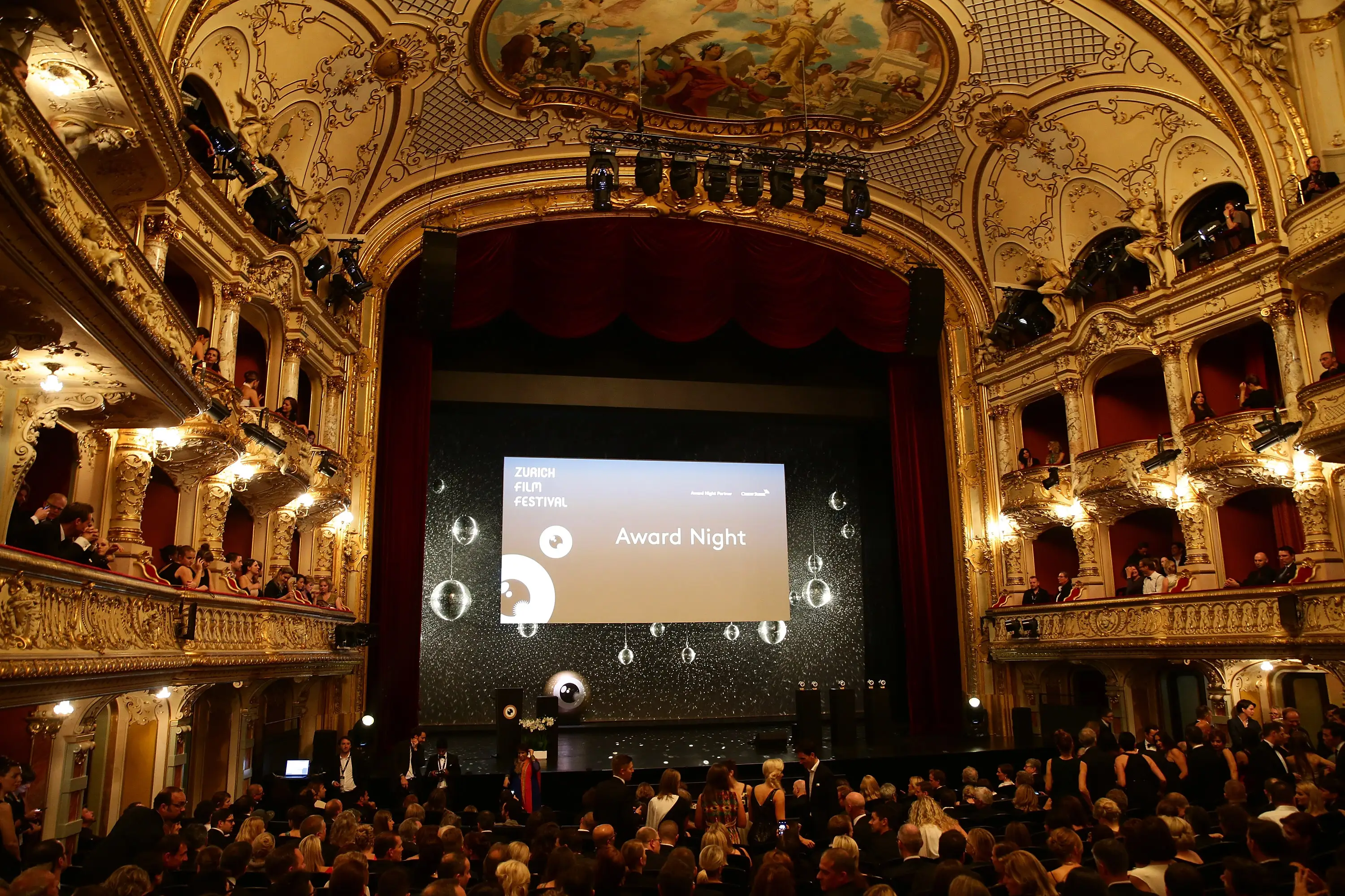Ornate theater filled with attendees during a ZURICH FILM FESTIVAL Award Night presentation.