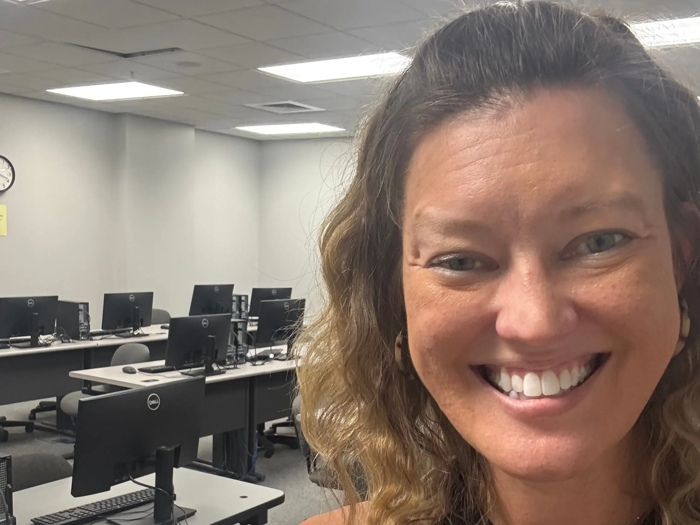 The author takes a selfie in the classroom where she teaches at a community college.