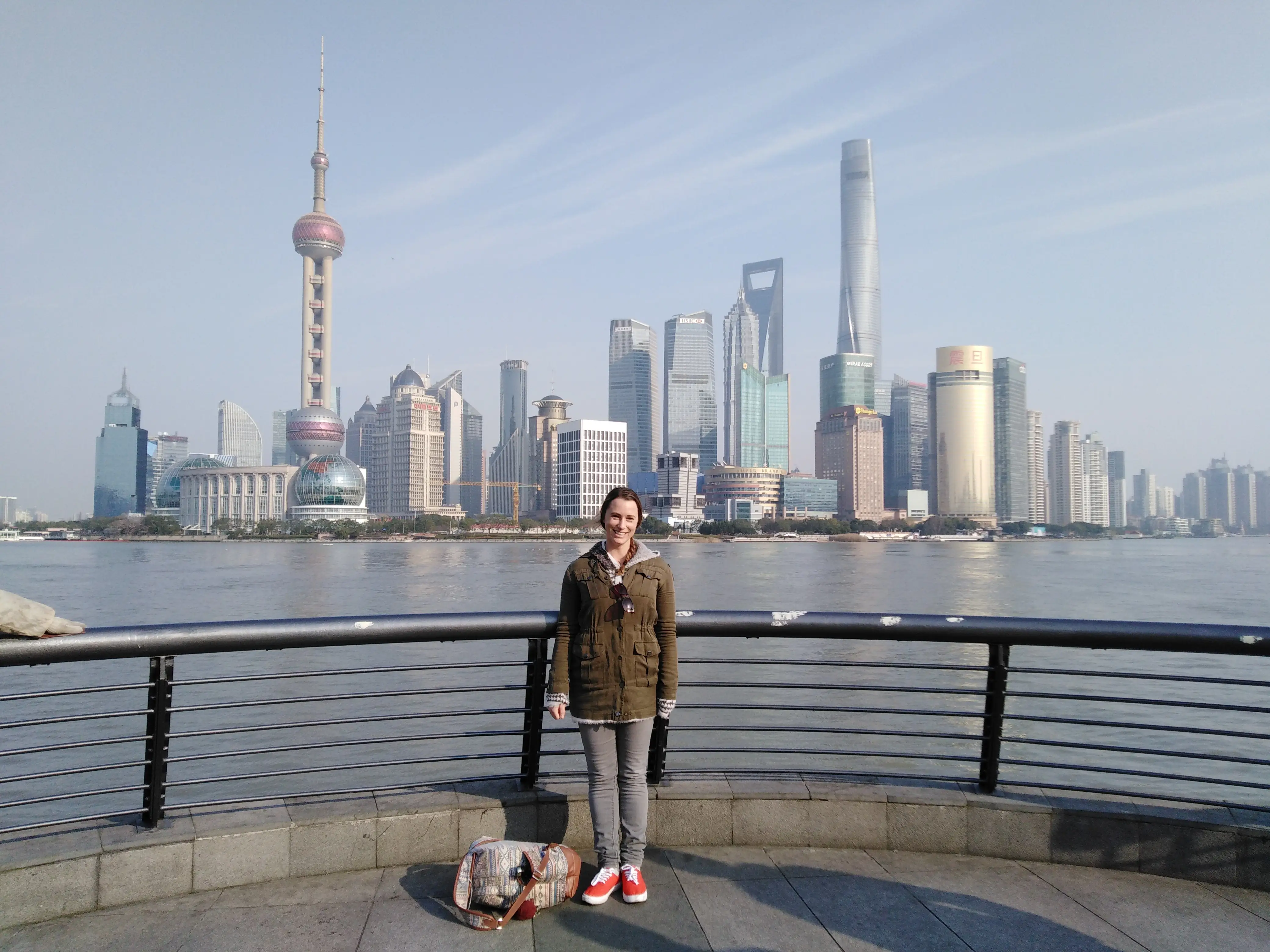 The author poses in front of the Shanghai, China skyline.