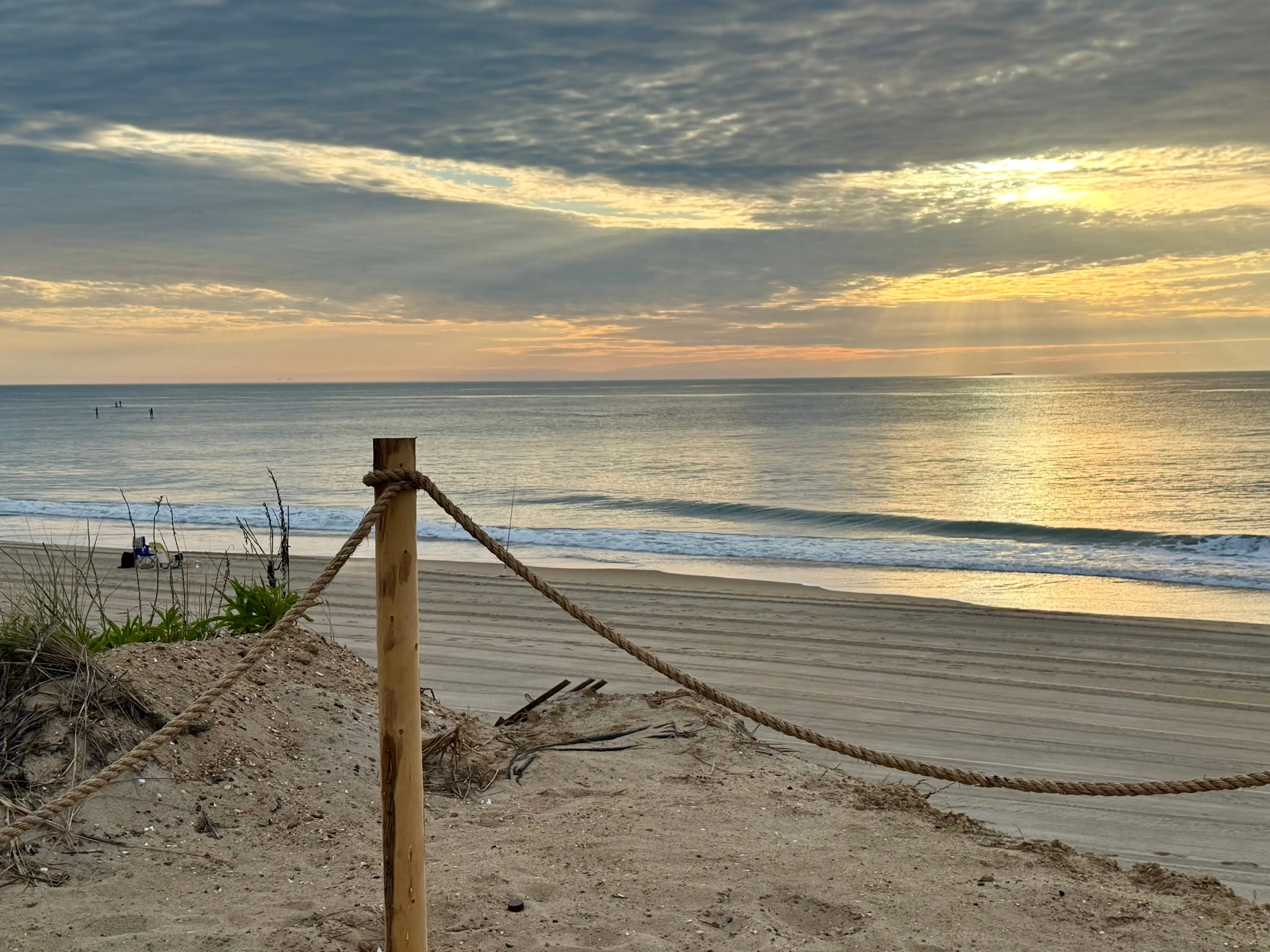 The sun peaking through the clouds at Bethany Beach in Delaware.