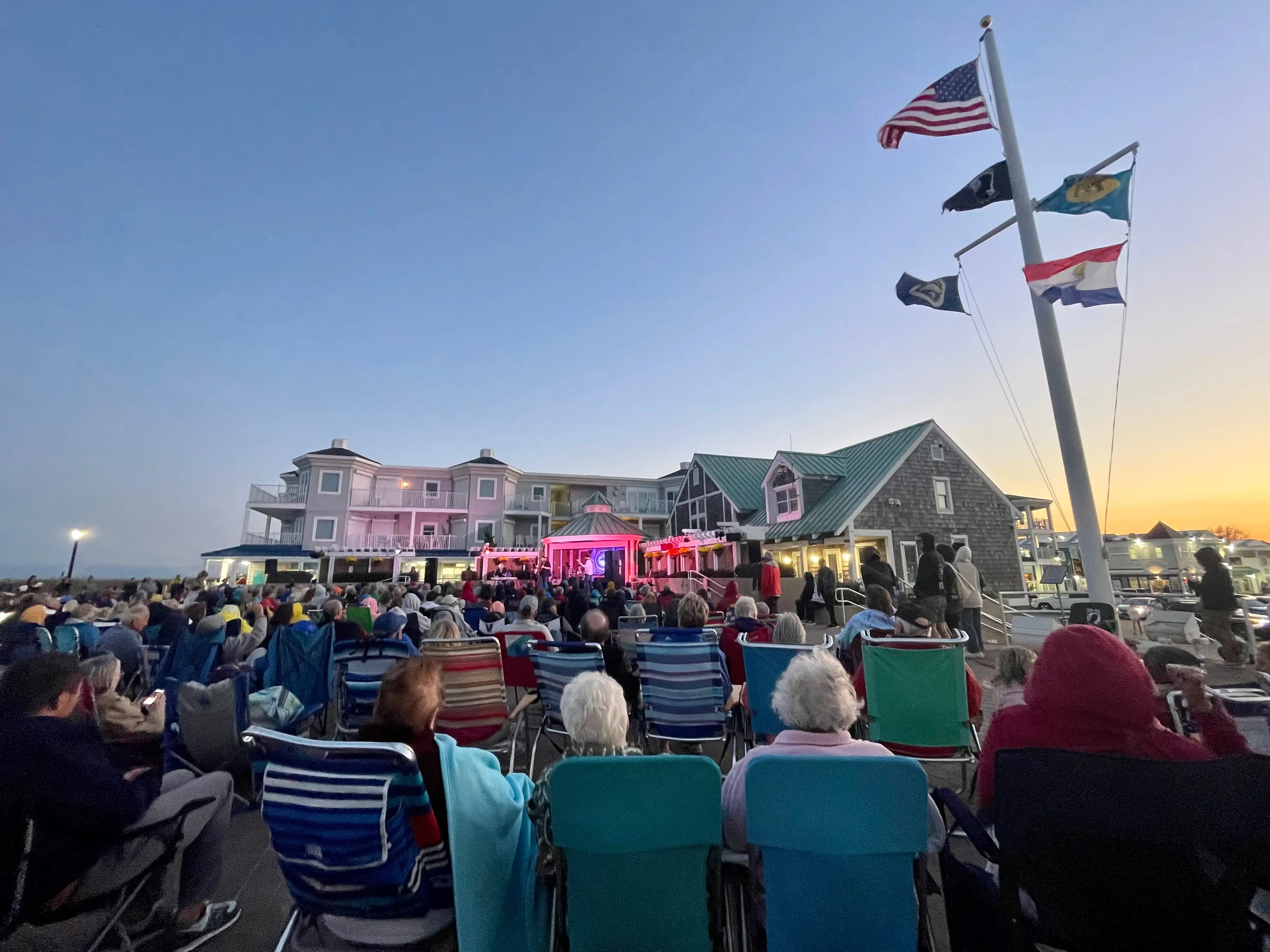 A crowd seated in folding chairs watching an outdoor concert in Bethany Beach, Delaware.
