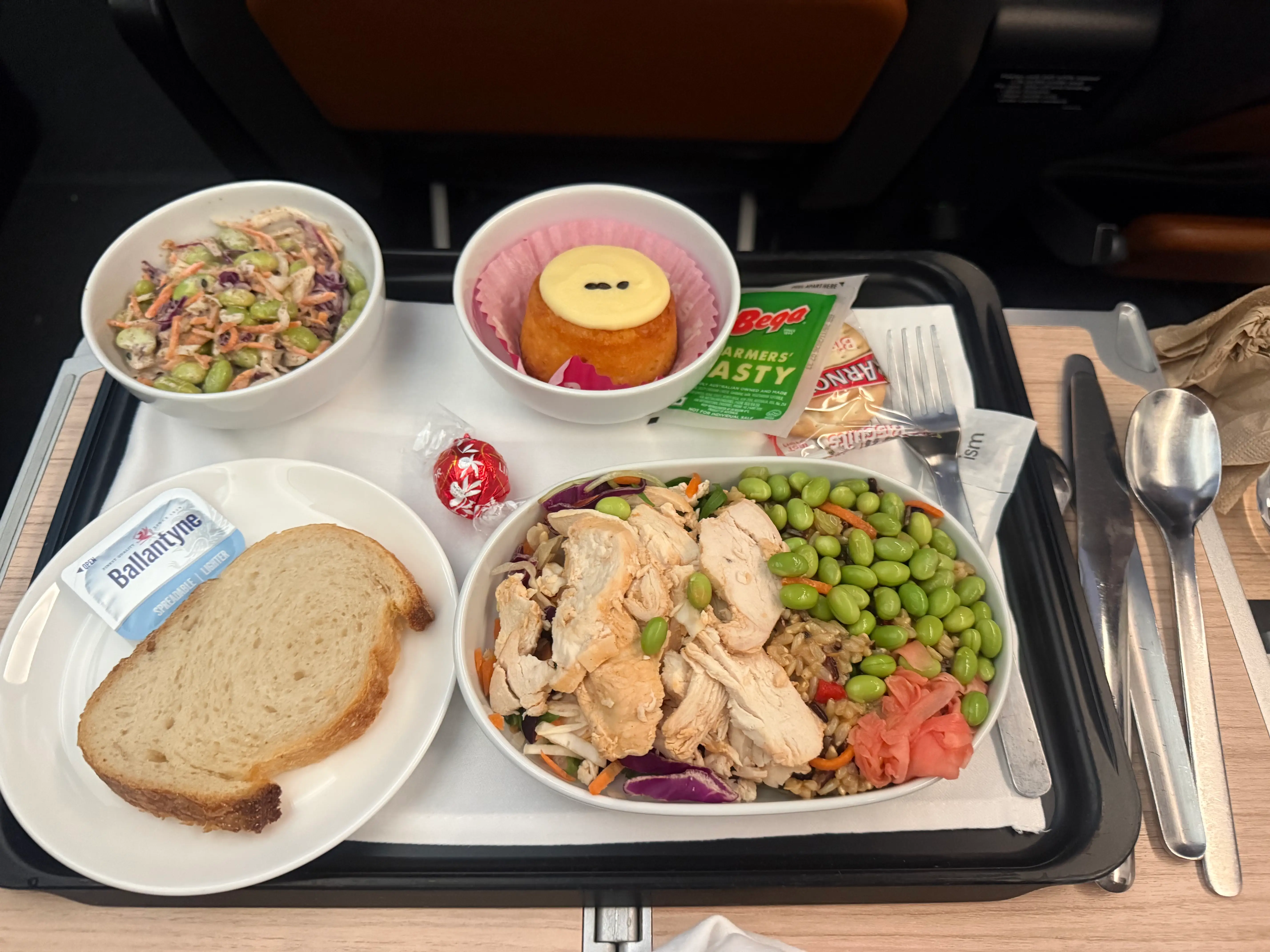 Tray of lunch with food on dishes on  Qantas premium flight