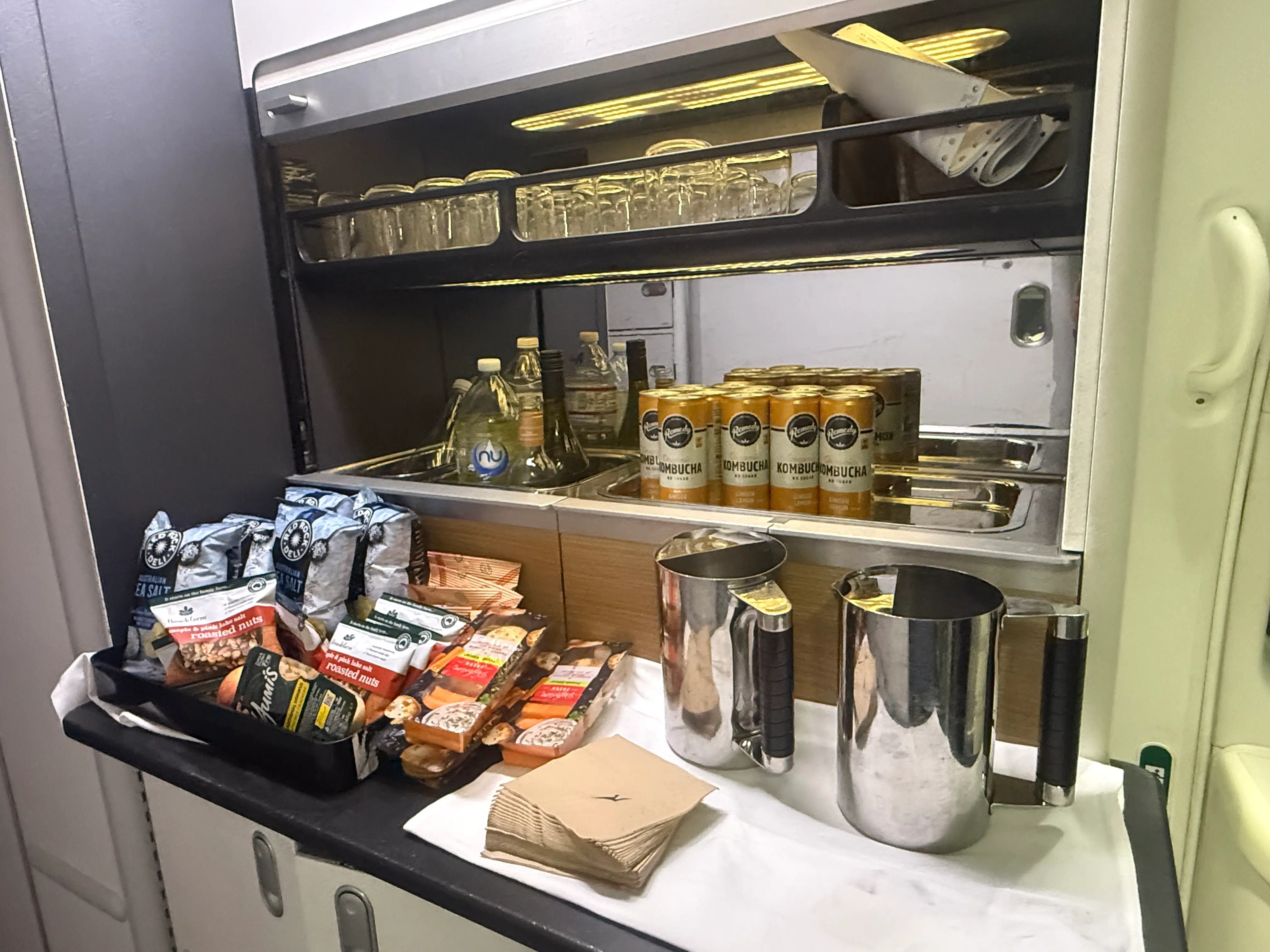 Snack bar area with kombucha and other snacks and drinks on  Qantas premium flight