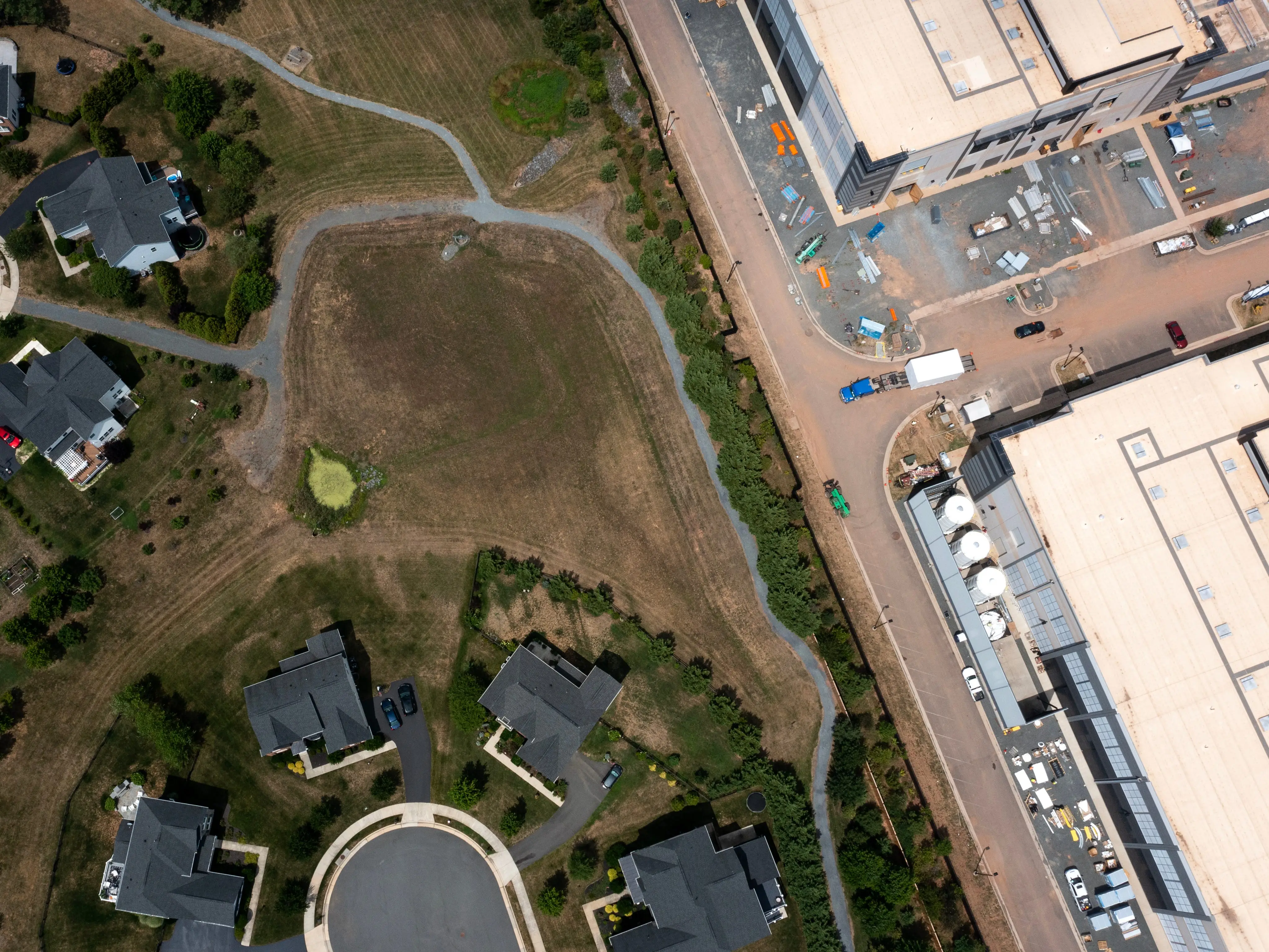 An aerial view showing homes next to a data center.