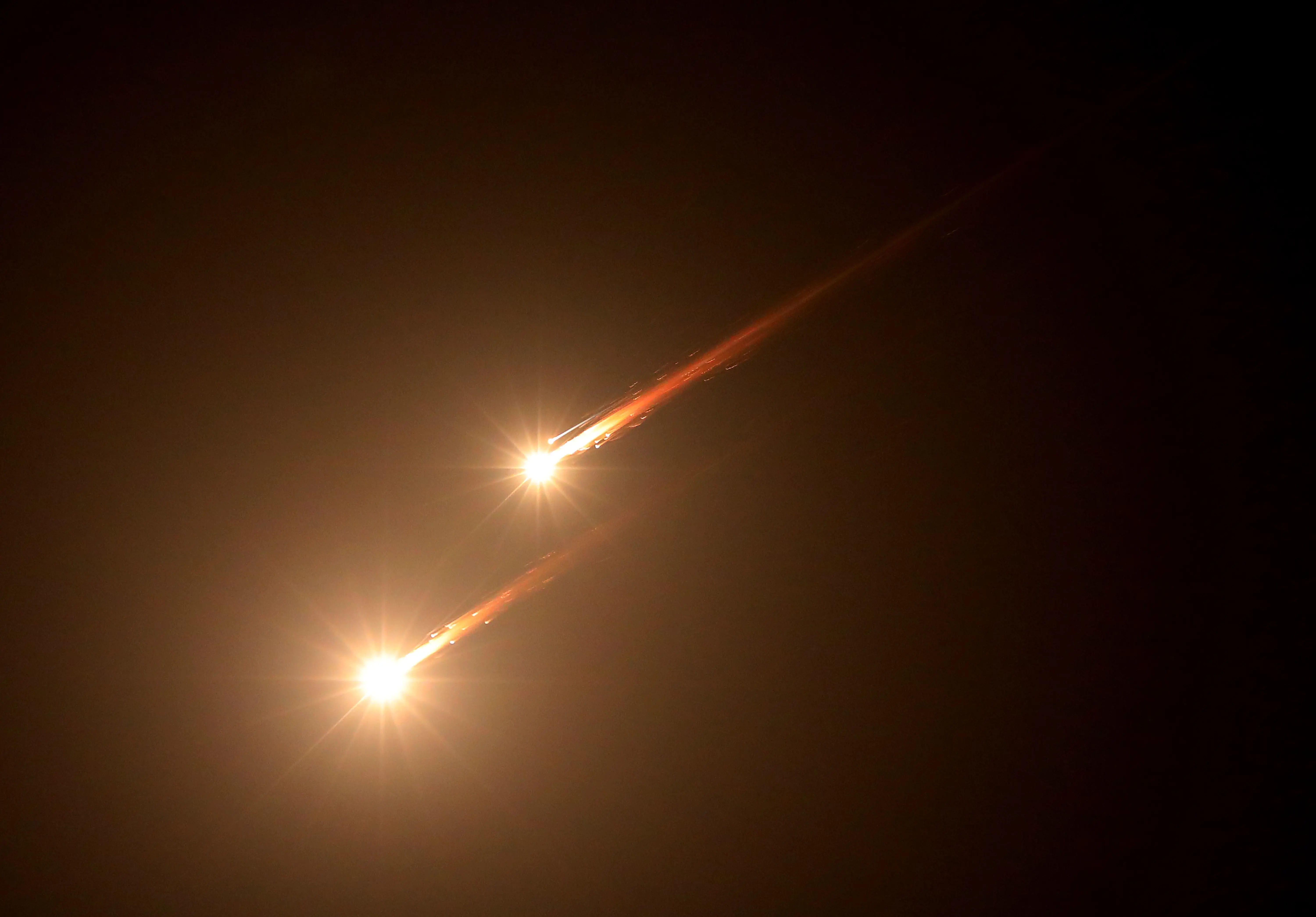 Iranian missiles streak across a dark sky