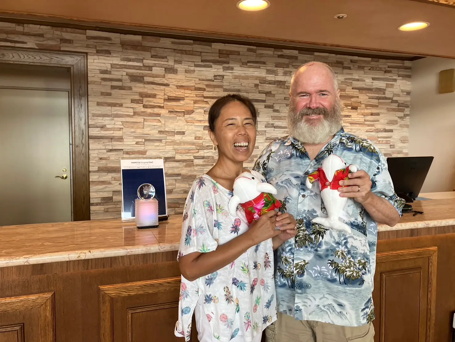 A couple posing with Japanese dolls.