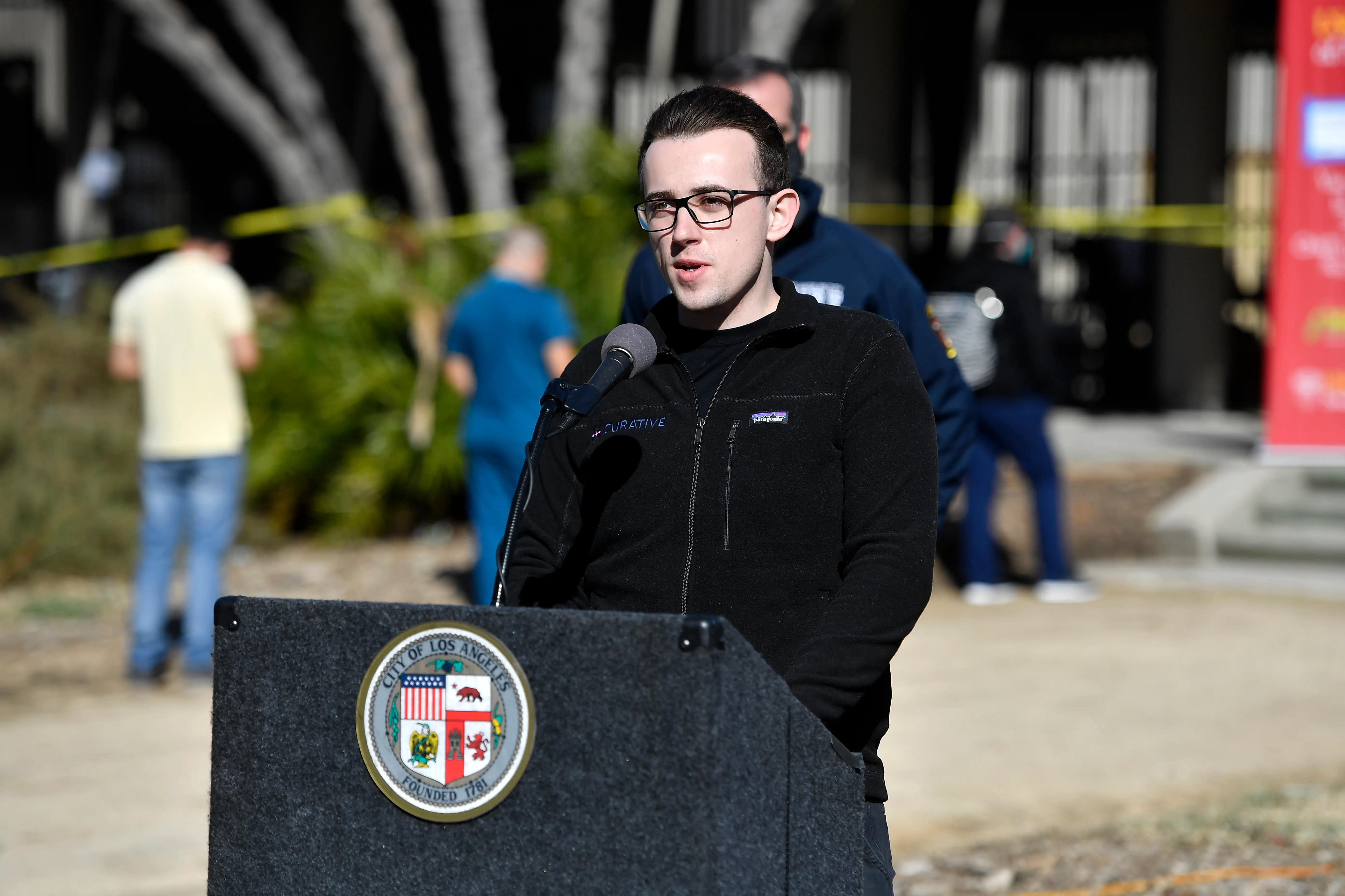 Curative CEO, Fred Truner, speaks at a lectern.