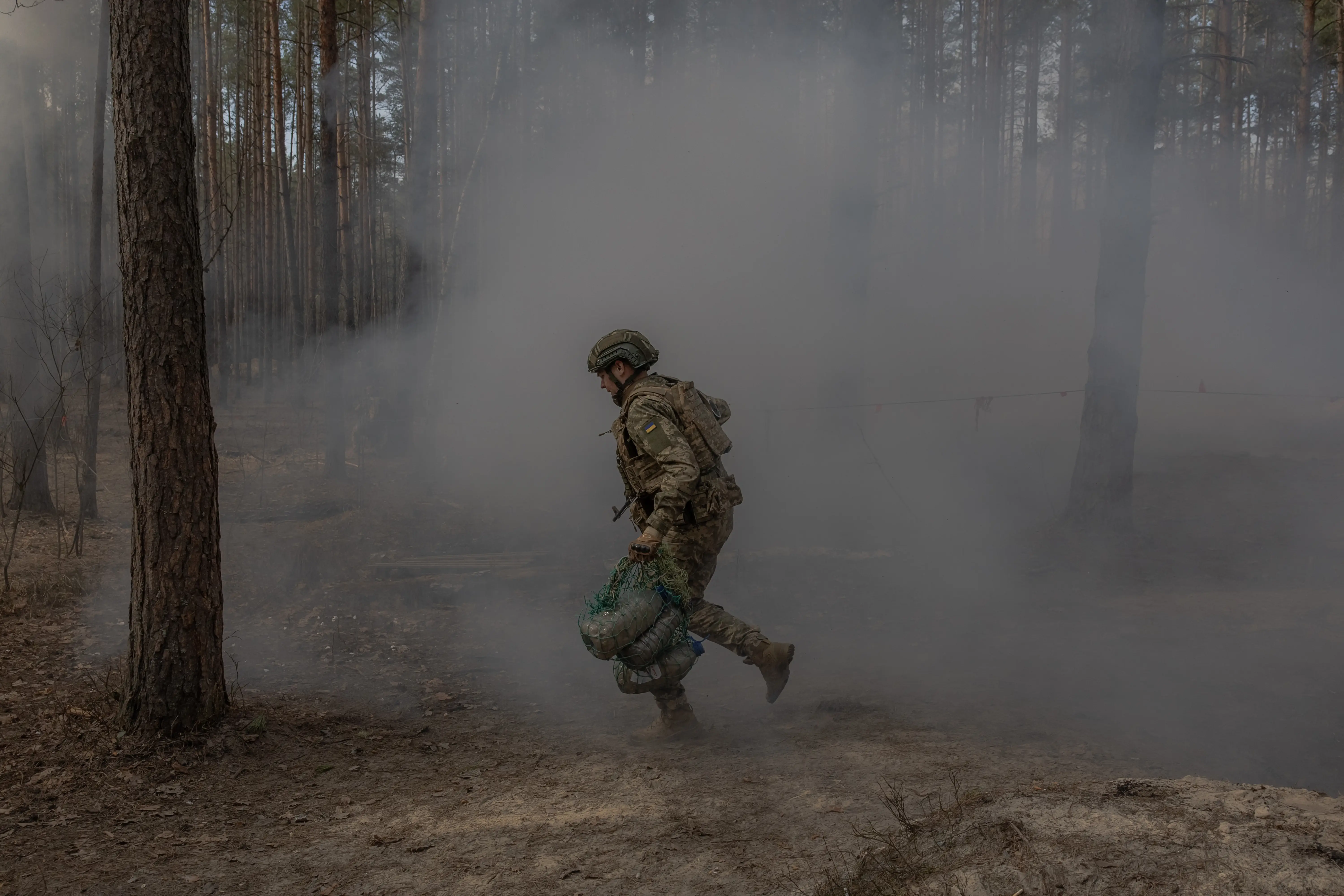 A Ukrainian recruit runs as he completes a basic military training at the Ukrainian Ground Forces training center in an undisclosed location on March 25, 2026, amid the Russian invasion of Ukraine.