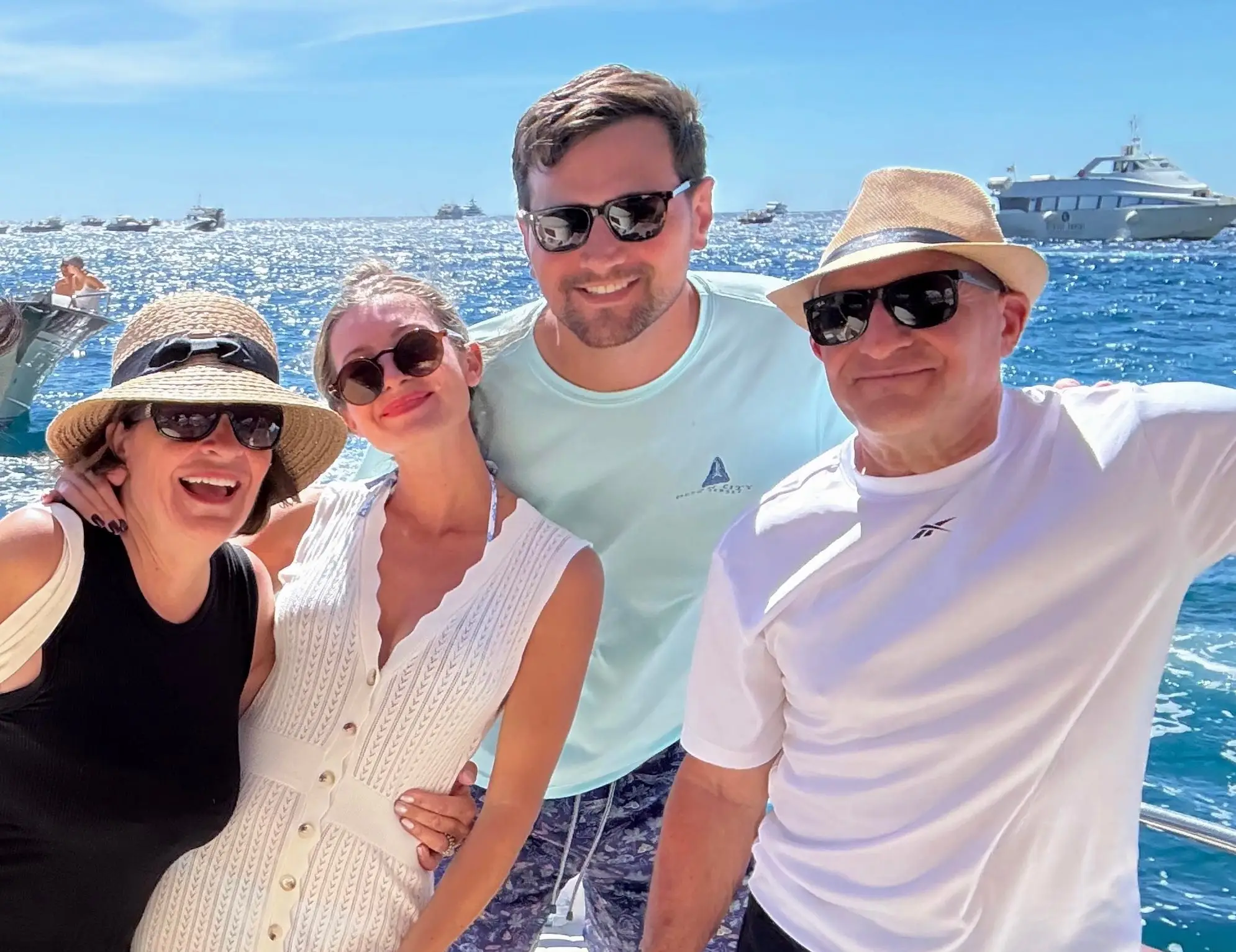 Group of people smiling on boat in ITaly