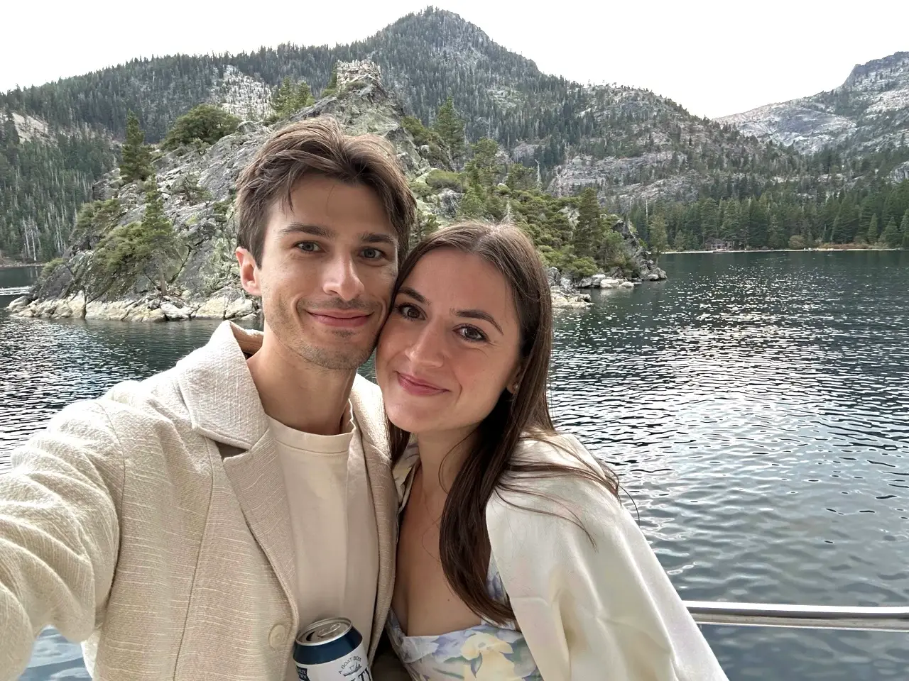 Man and woman smiling in front of Emerald Bay