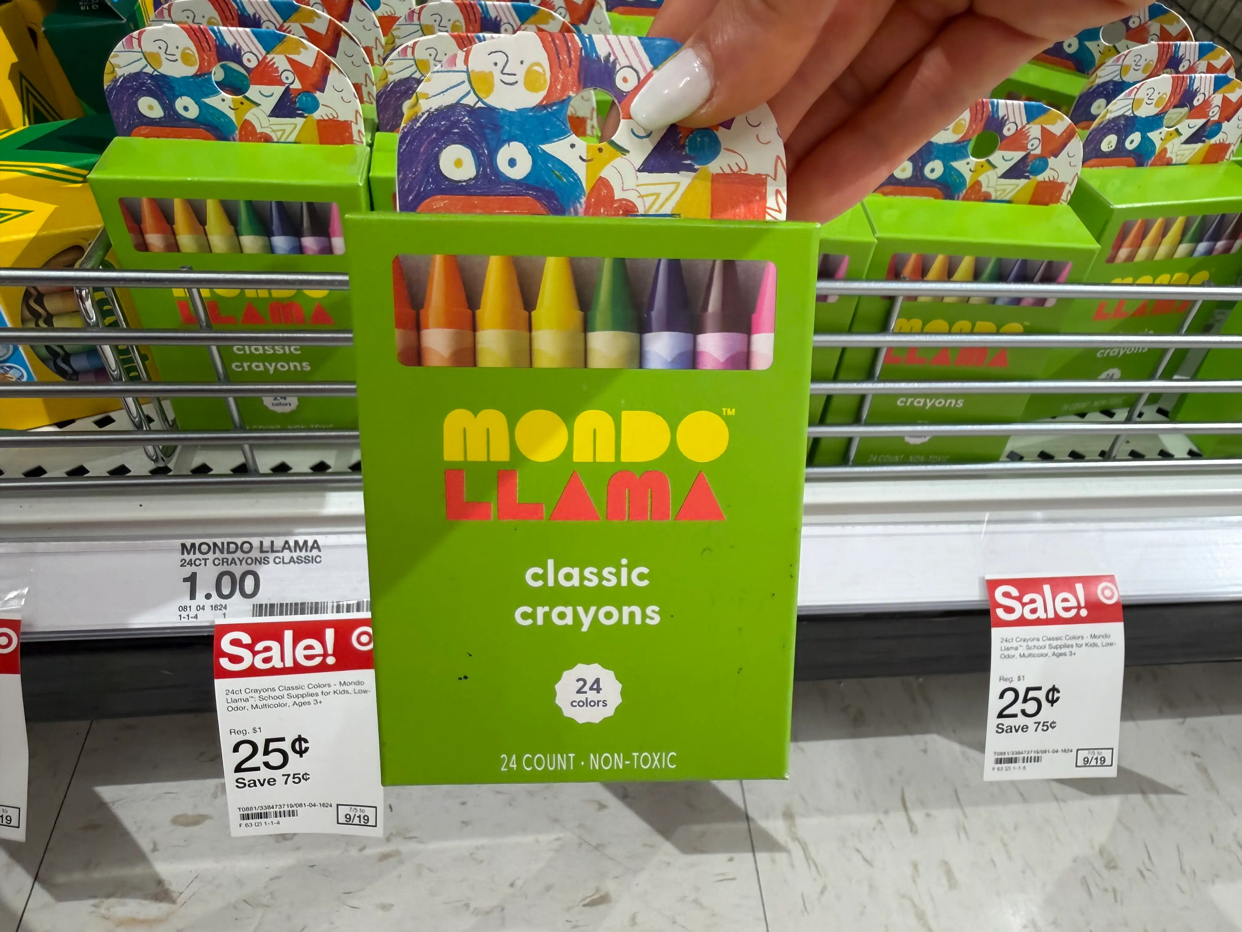 Hand holding pack of Mono Llama 24-pack crayons at Target