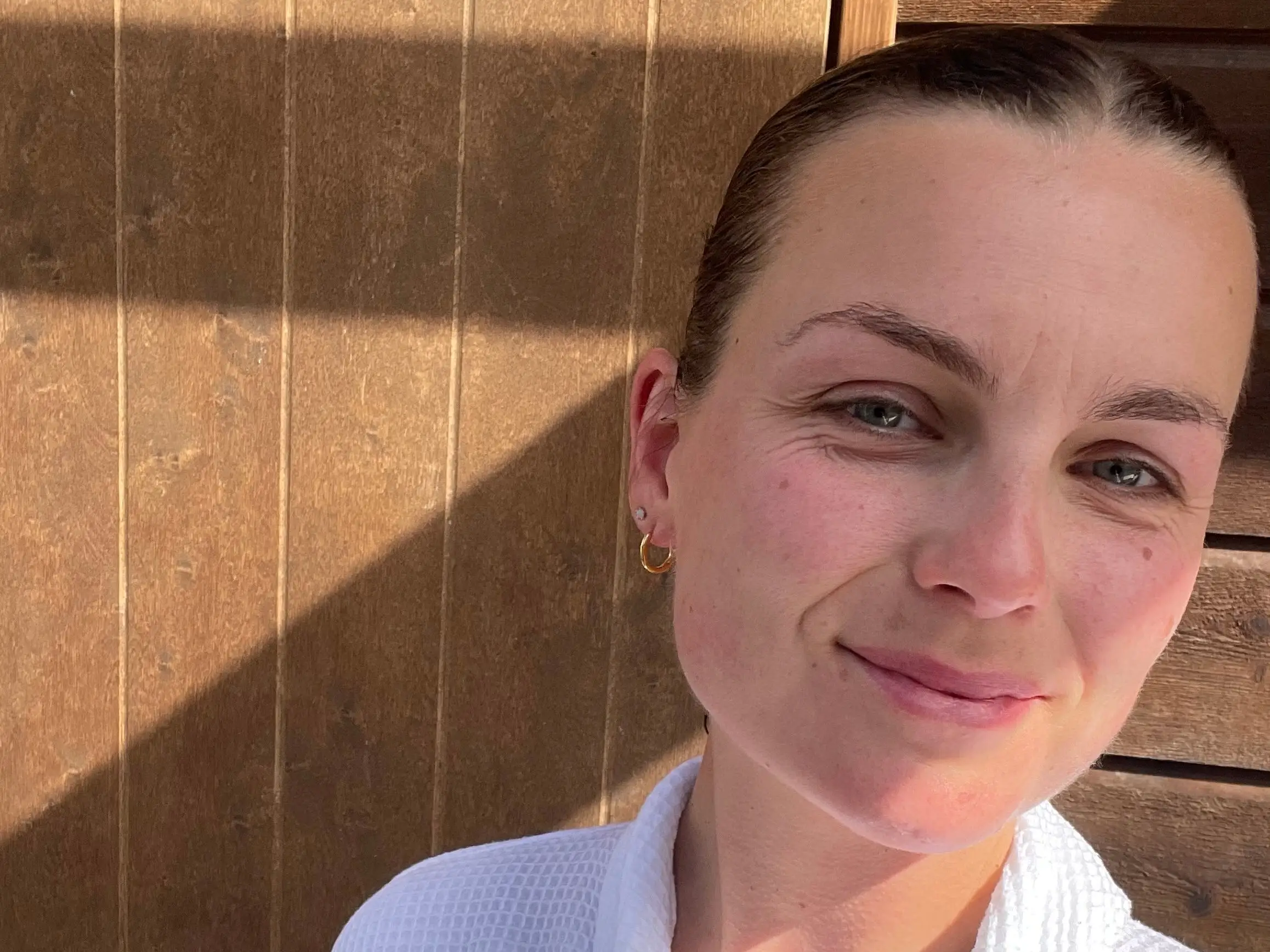 A woman wearing a bathrobe at the sauna in Norway.