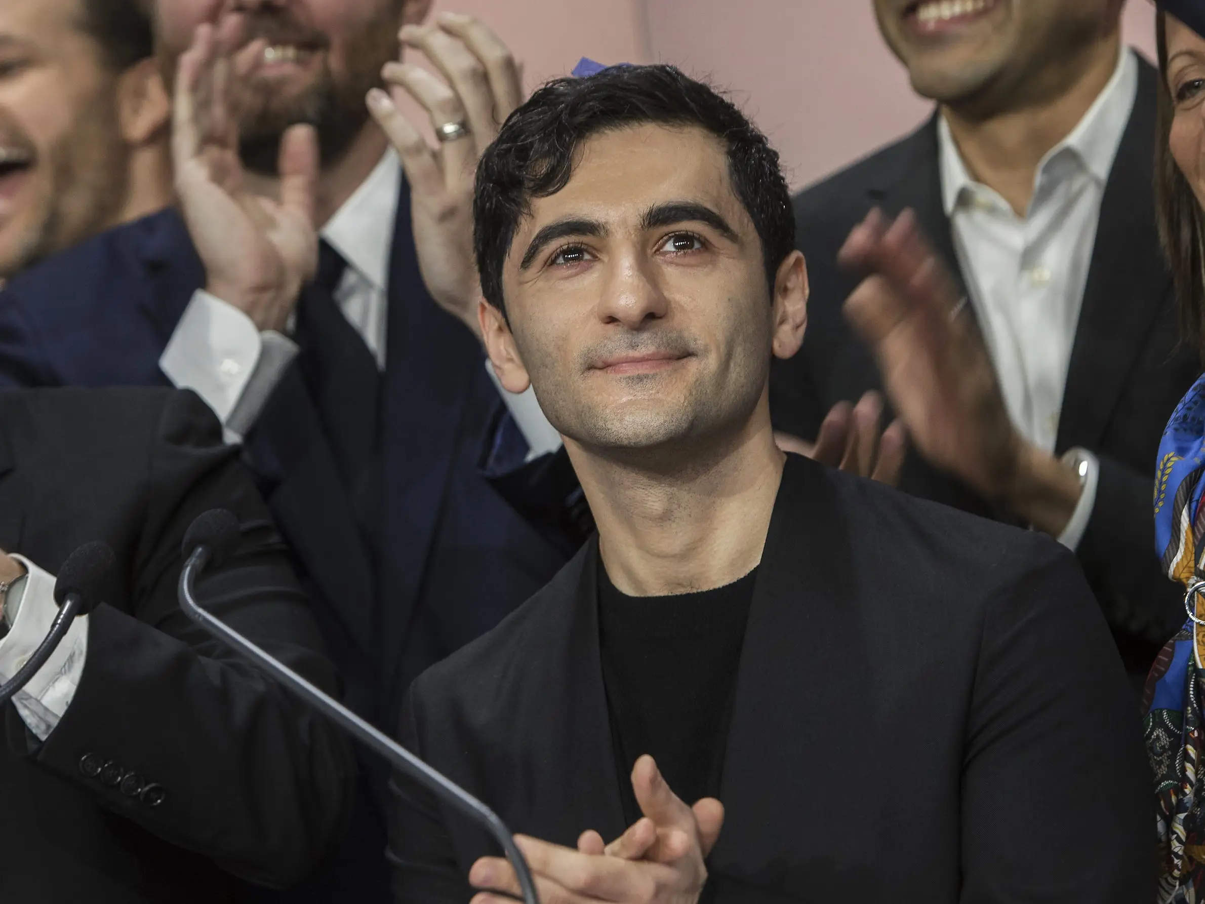 Arash Ferdowsi, cofounder of Dropbox, applauds during the company's IPO at the Nasdaq MarketSite in New York,