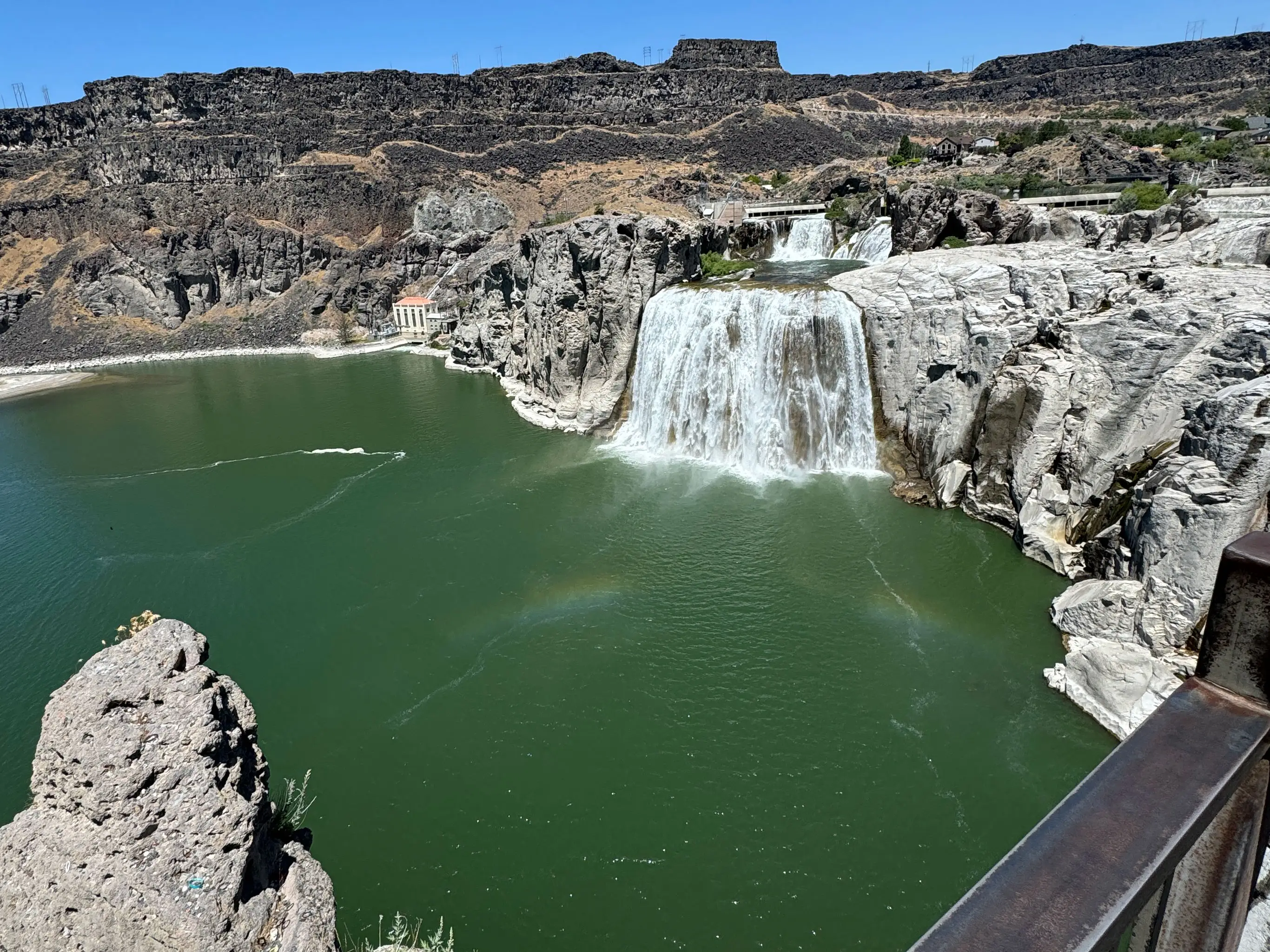 A waterfall that's surrounded by a basalt canyon.