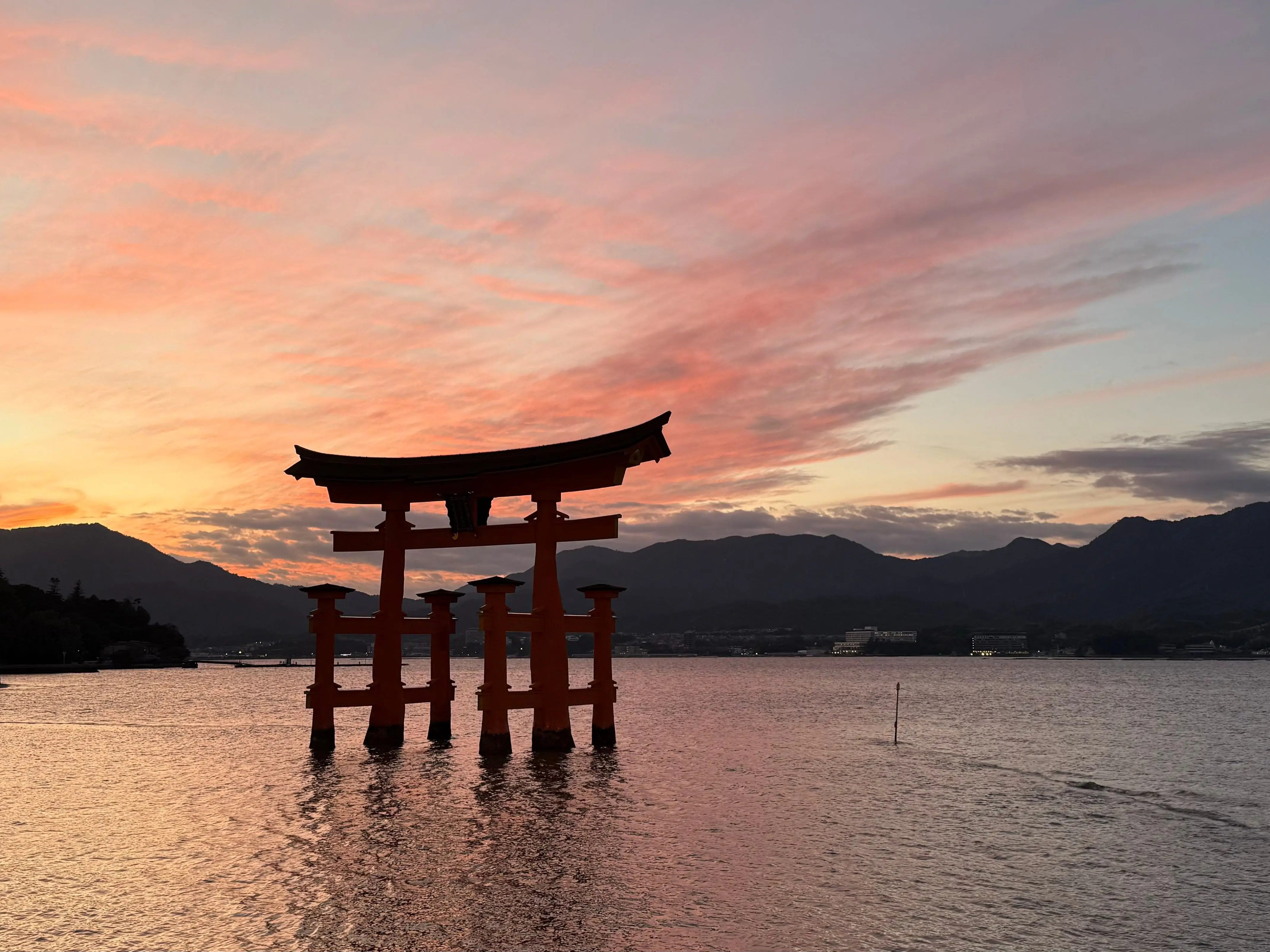 Itsukushima Shinto Shrine peaking through the water in Miyajima, Japan.