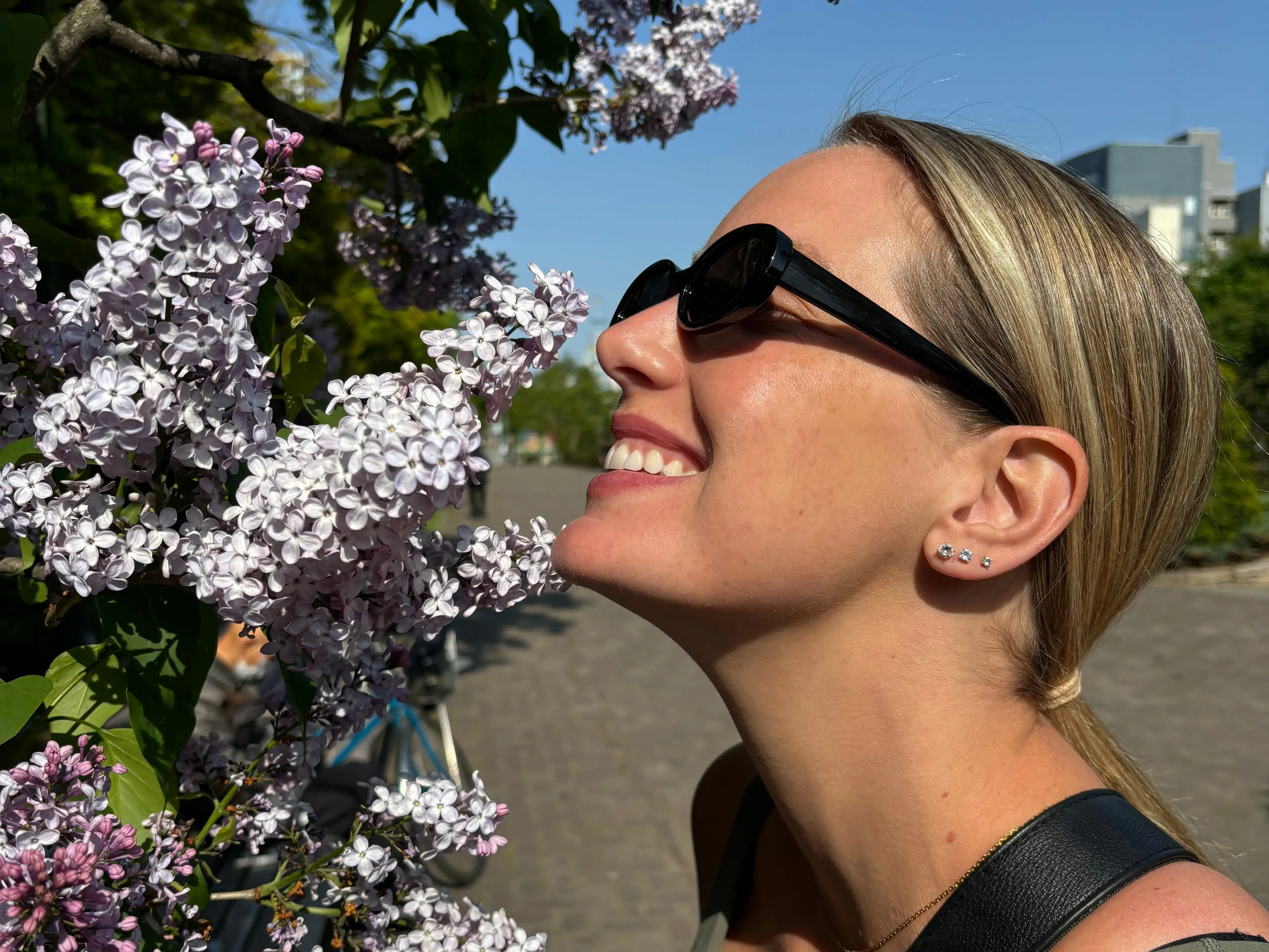 The writer smelling cherry blossoms in Sapporo, Japan.
