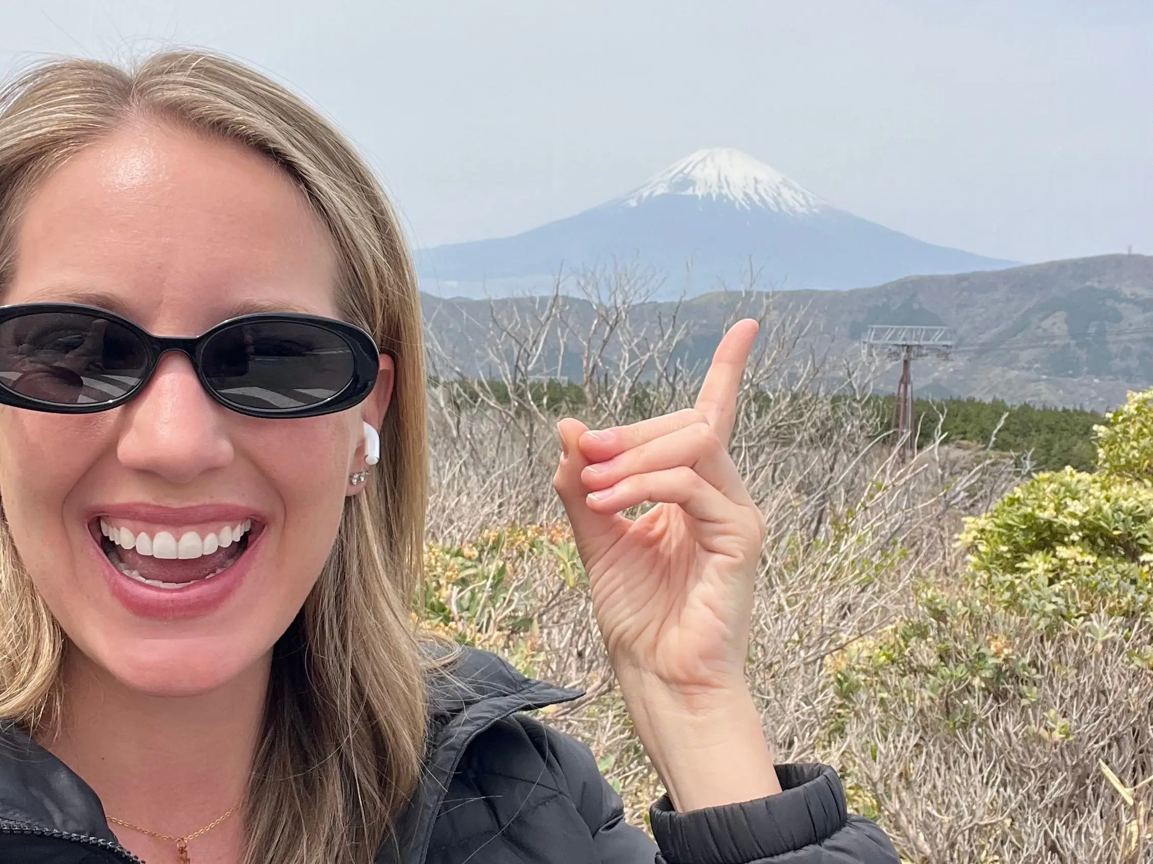 The writer pointing to Mount Fuji in Hakone, Japan.