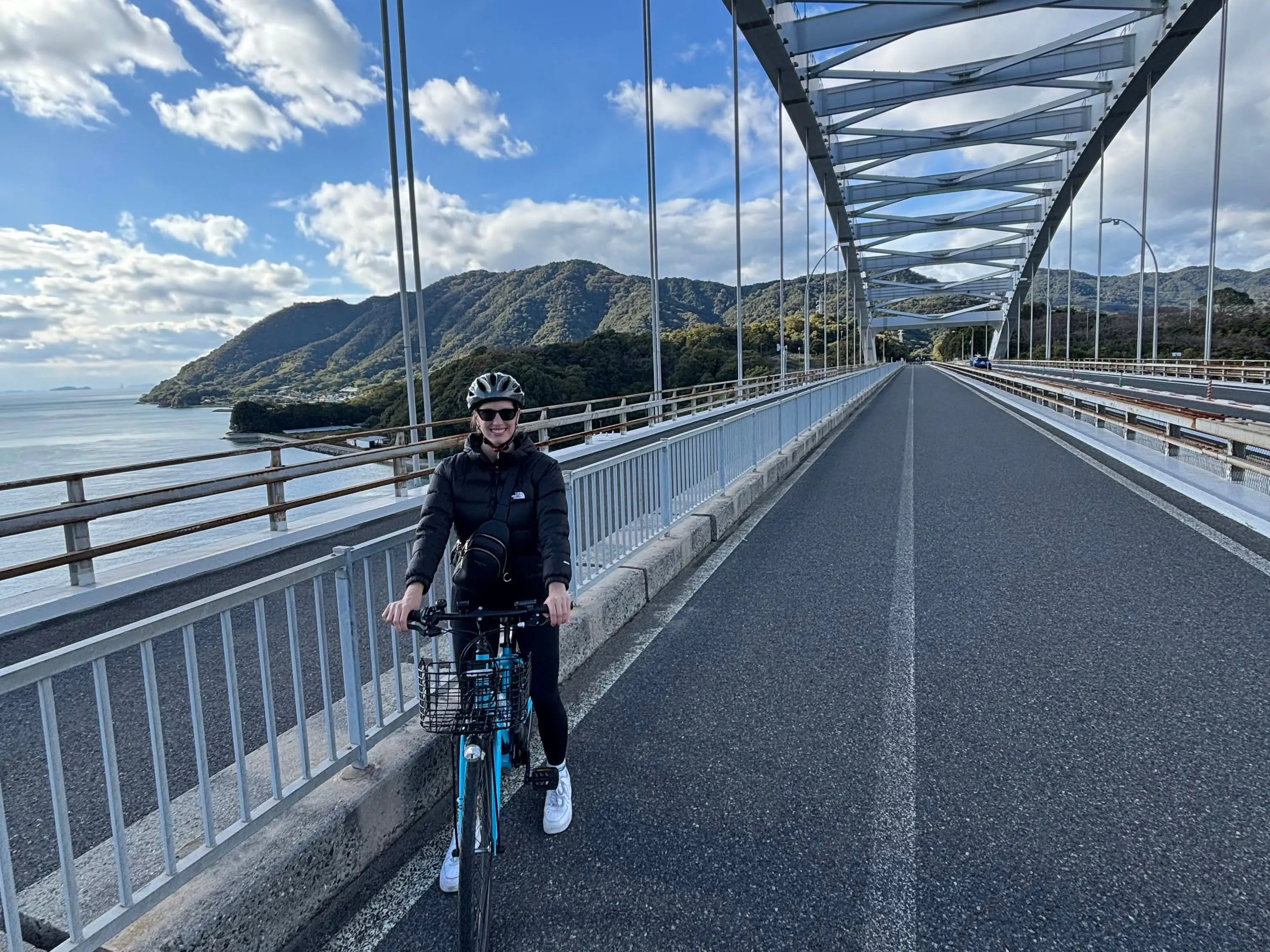 The writer riding a bike along the Shimanami Kaido cycling route in Japan.