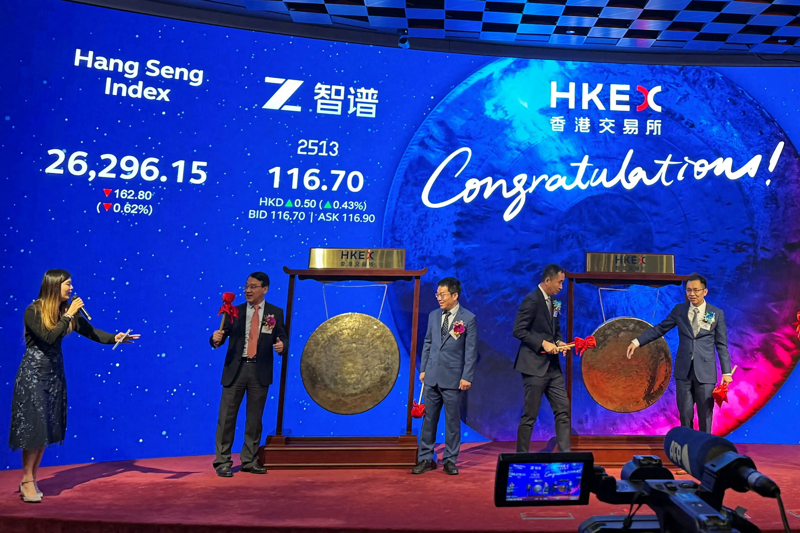 Executives from artificial intelligence company Zhipu AI, also known as Knowledge Atlas Technology, semiconductor company Shanghai Iluvatar CoreX and surgical robotics company Shenzhen Edge Medical attend a listing ceremony at the Hong Kong Stock Exchange, in Hong Kong, China January 8, 2026.