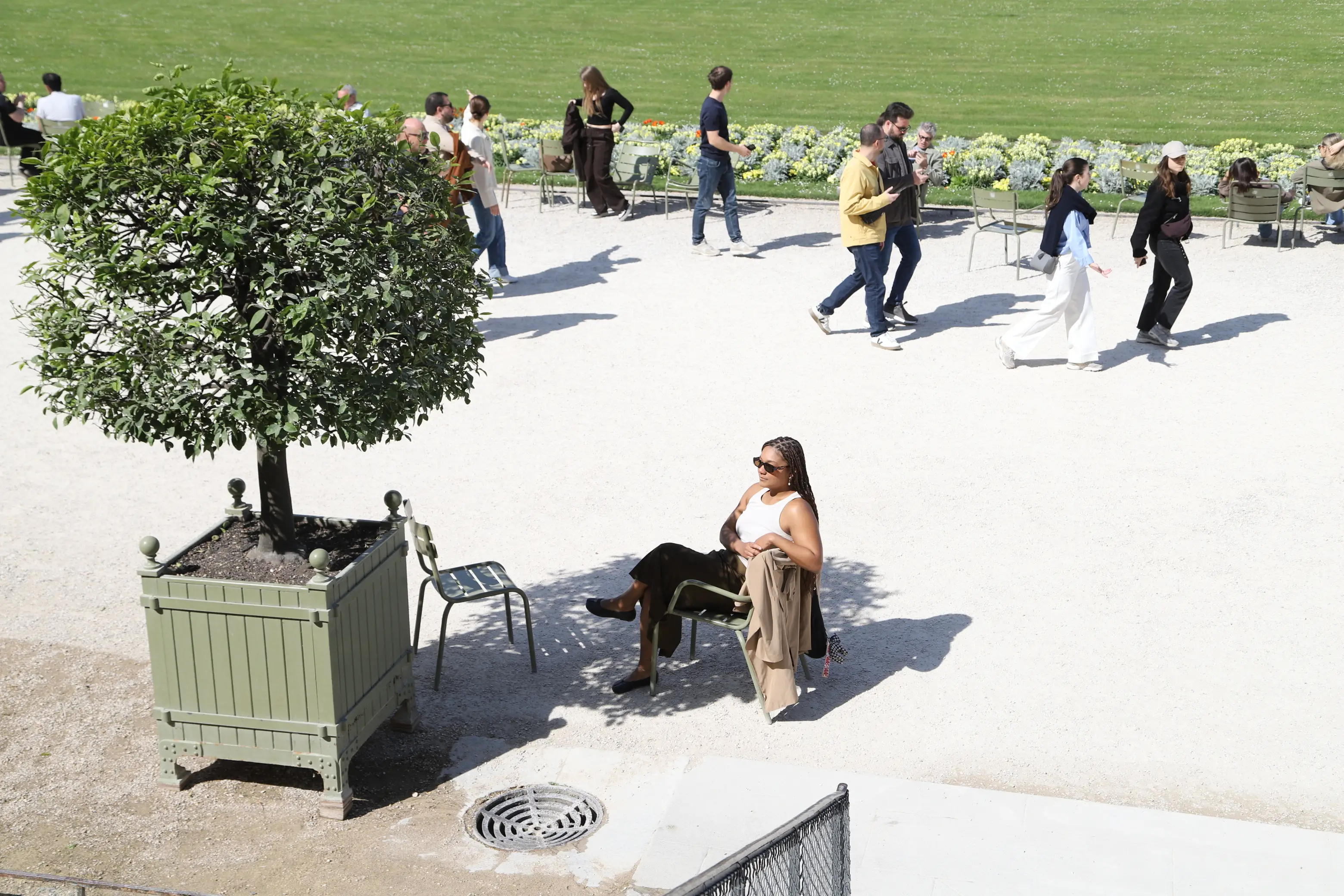 Woman with sunglasses on sitting in park in France