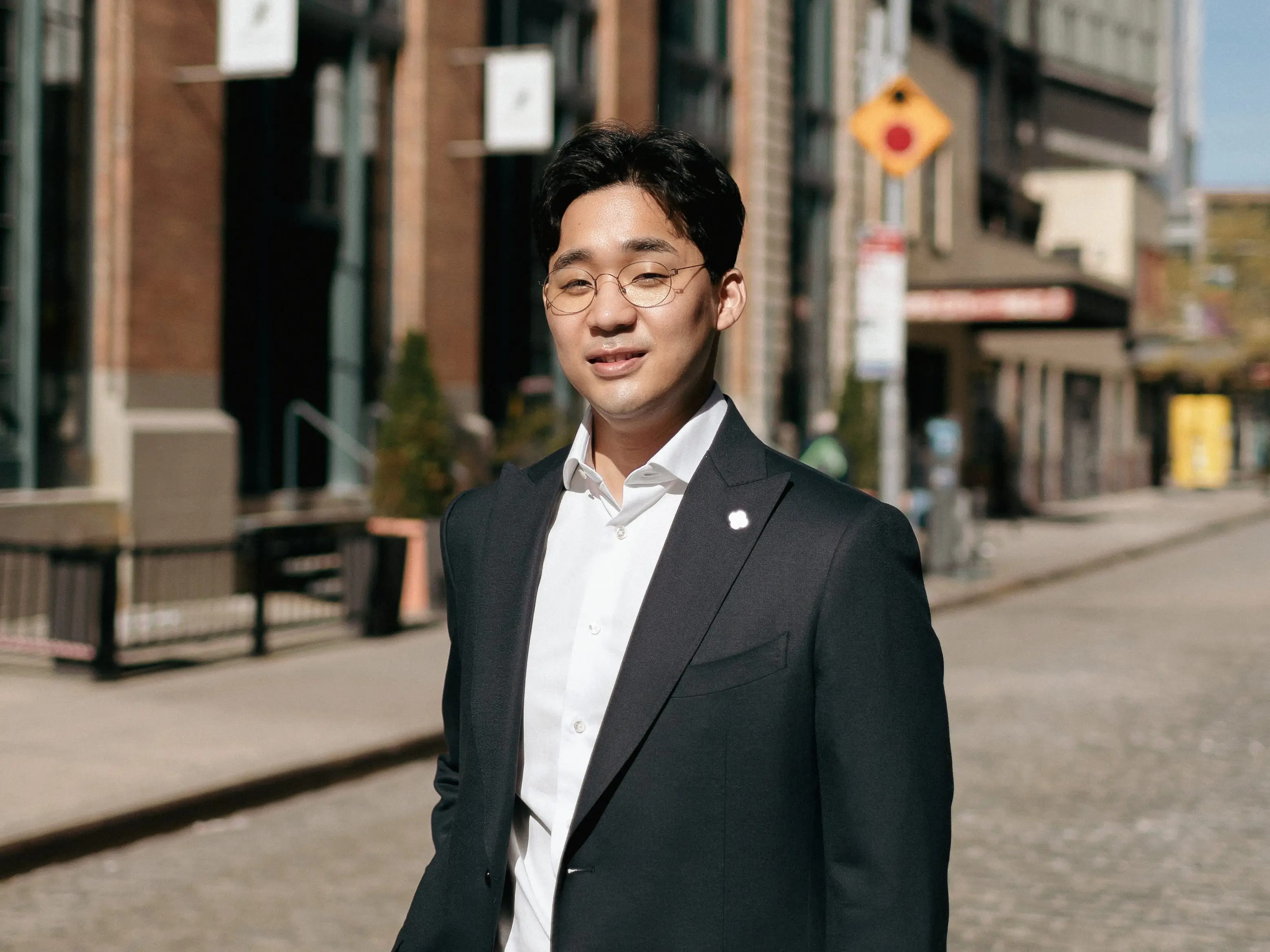 Black Jays Ventures' Jay Kim, wearing a suit on a cobblestone street.