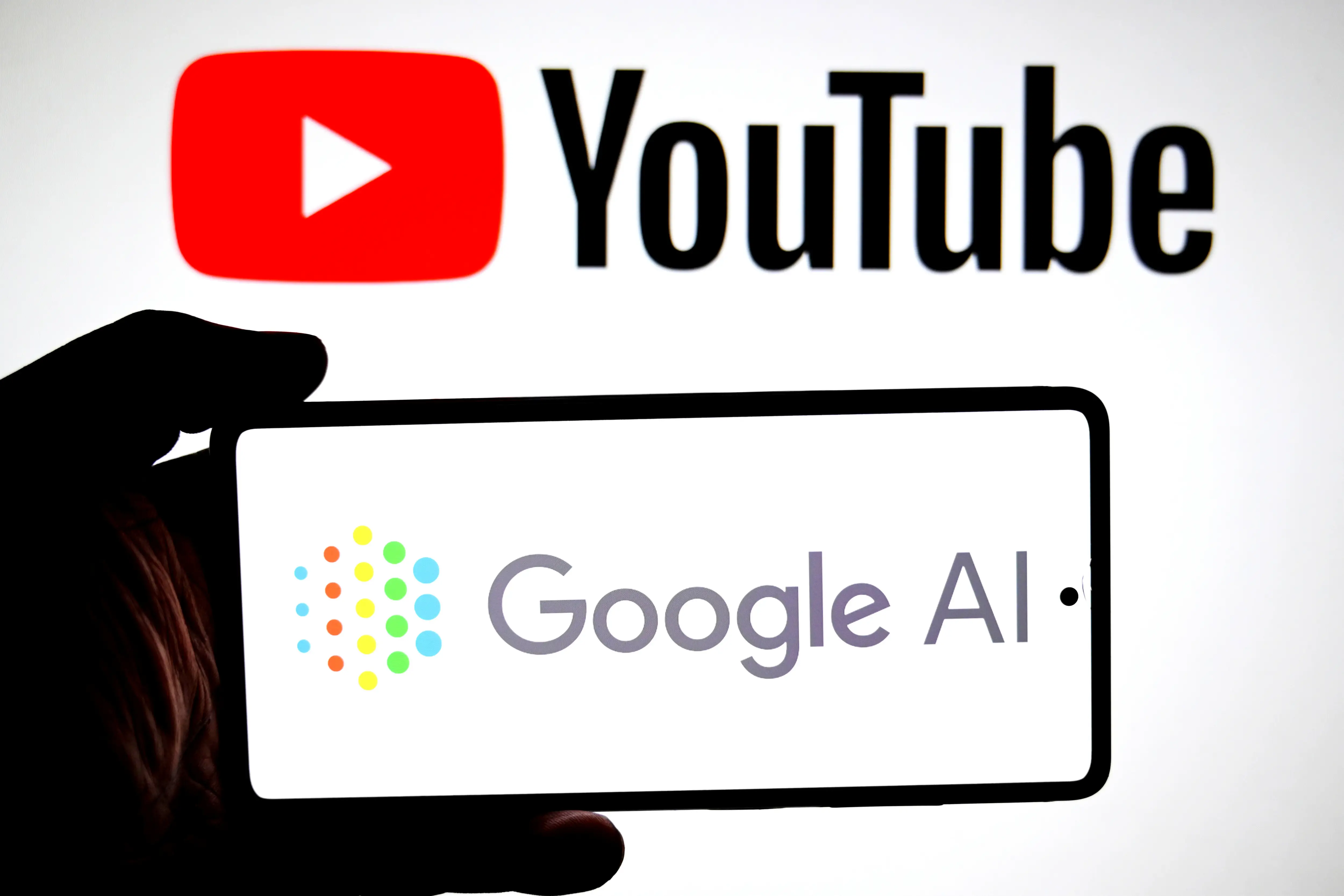 In this photo illustration, a Google AI logo is seen displayed on a smartphone with a Youtube logo in the background. (Photo Illustration by Avishek Das/SOPA Images/LightRocket via Getty Images)