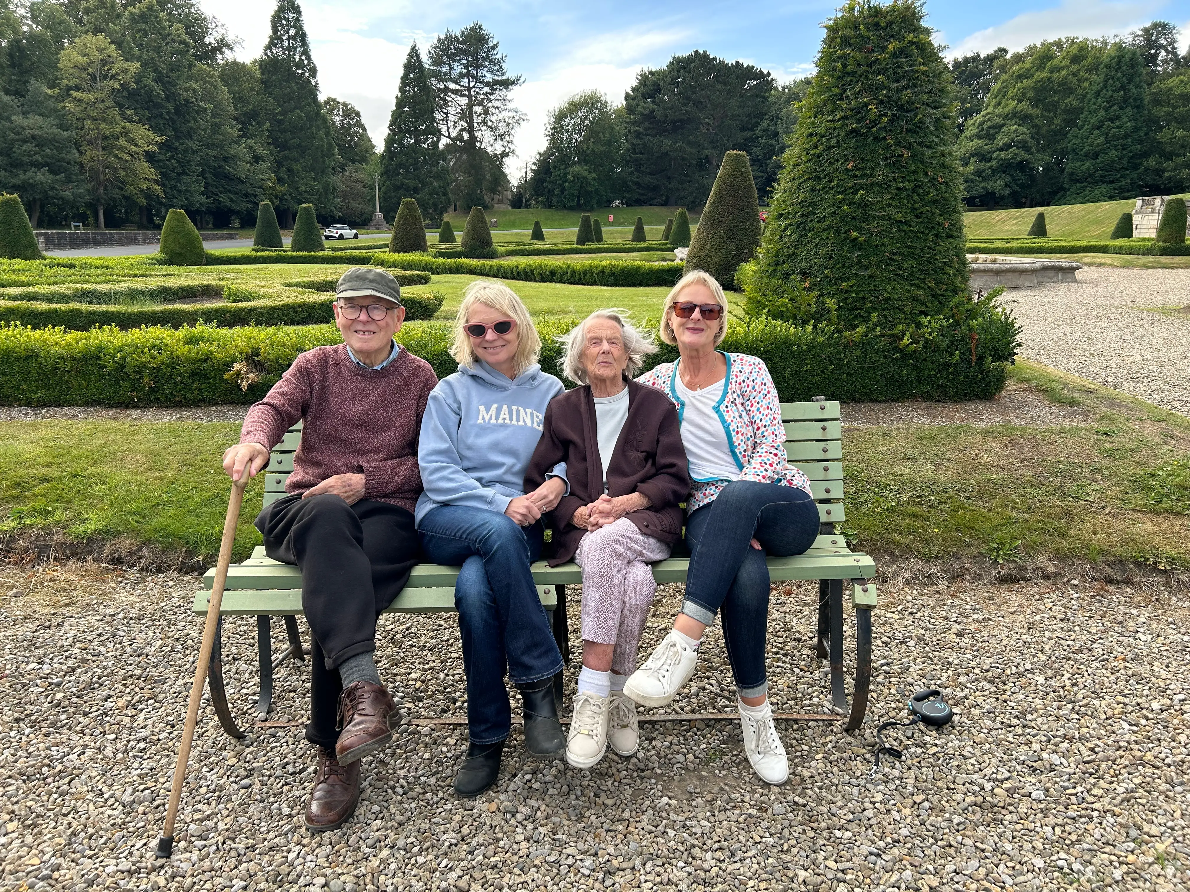 A family of four sitting on a bench