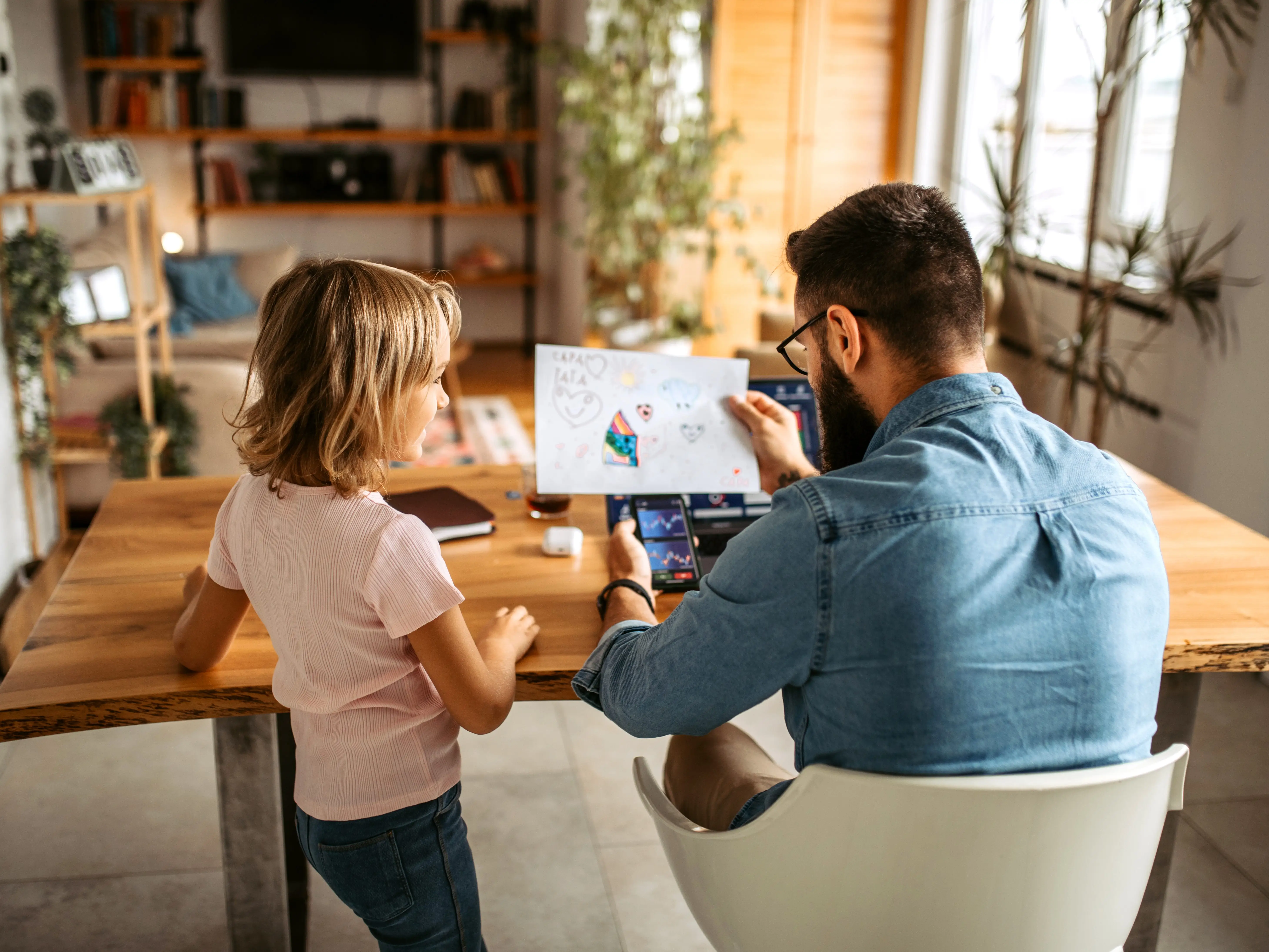 father working from home and spending time with his kids
