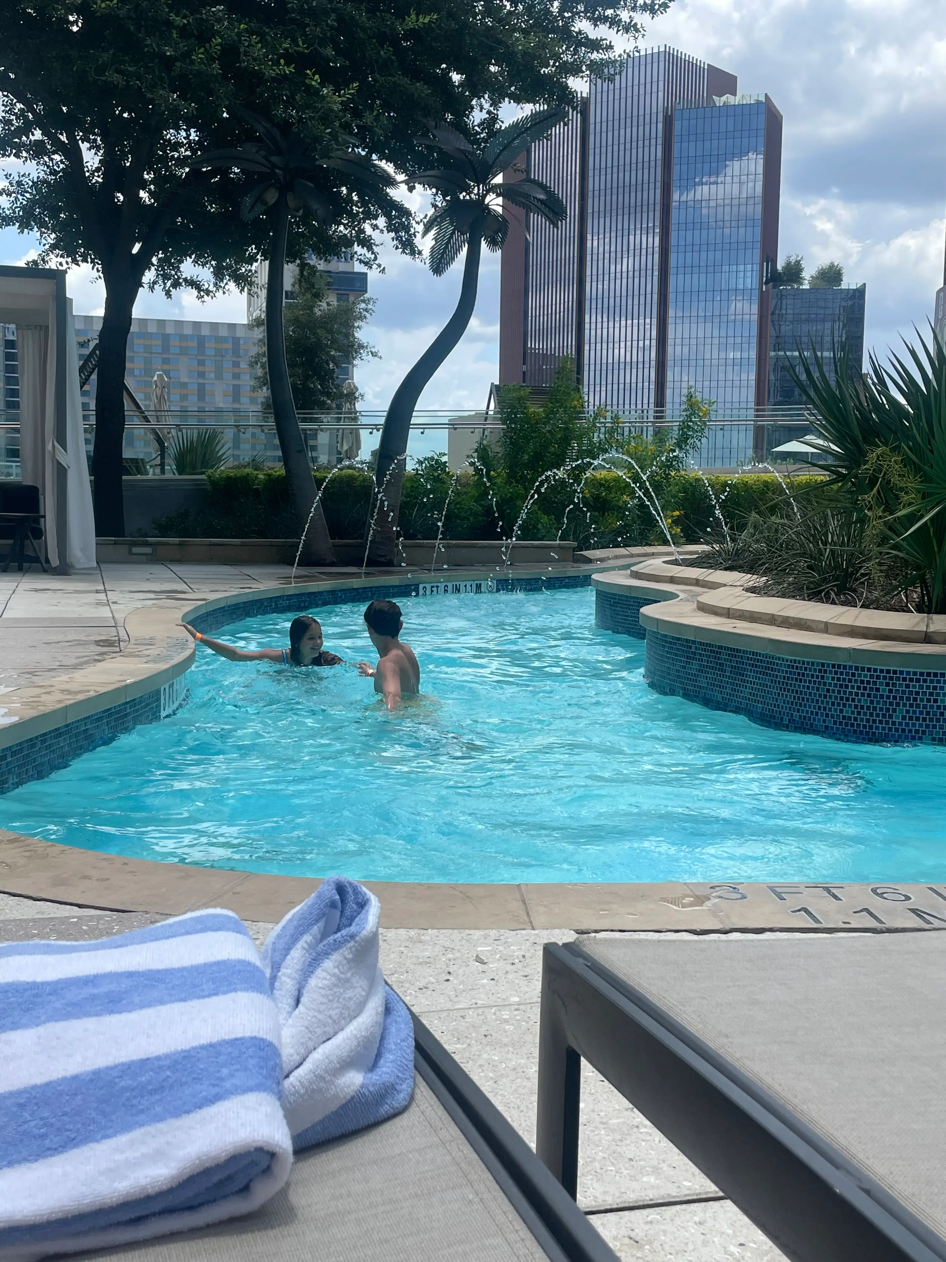 Two kids play in a lazy river.