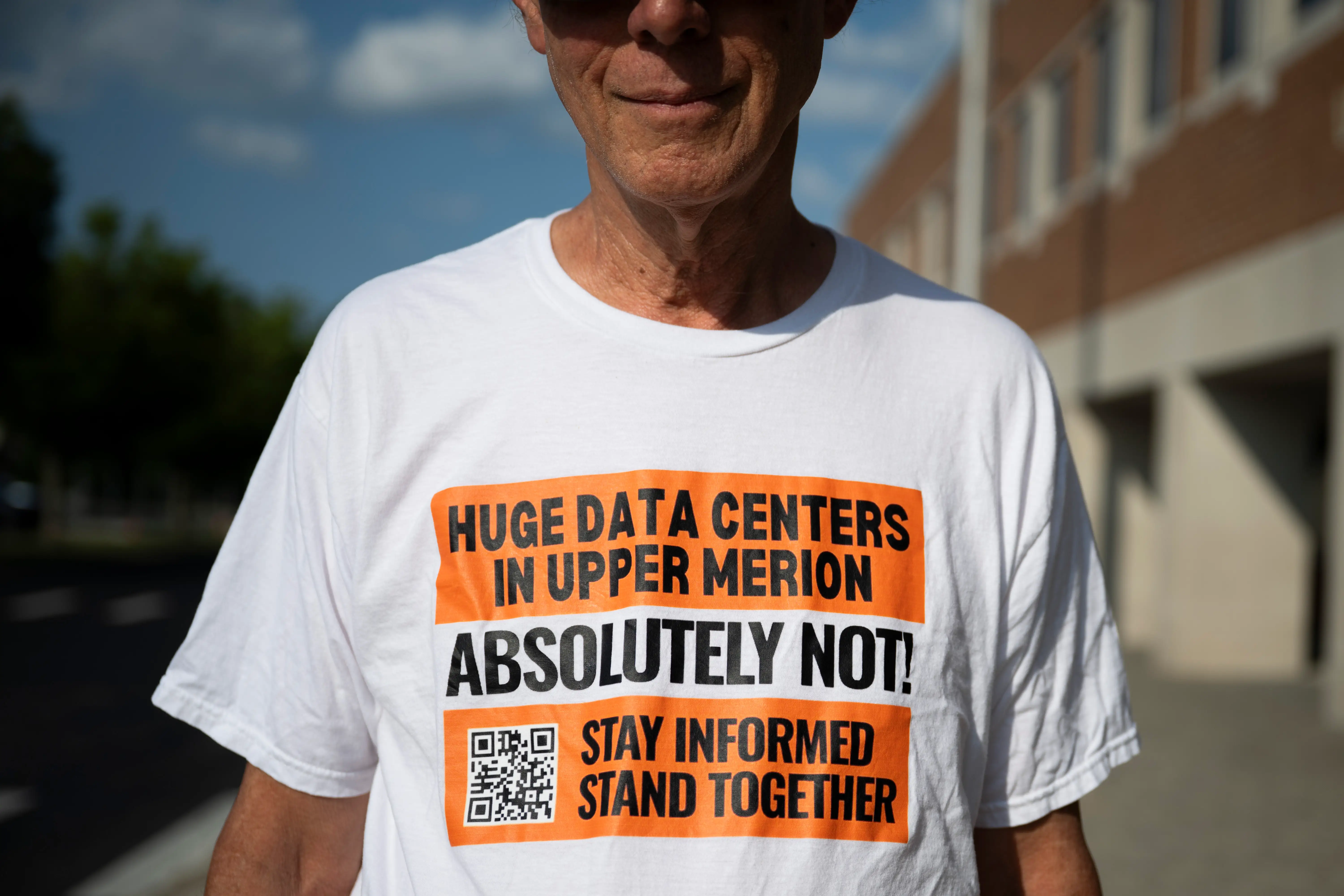 A man wears a shirt opposing an AI data center in Pennsylvania