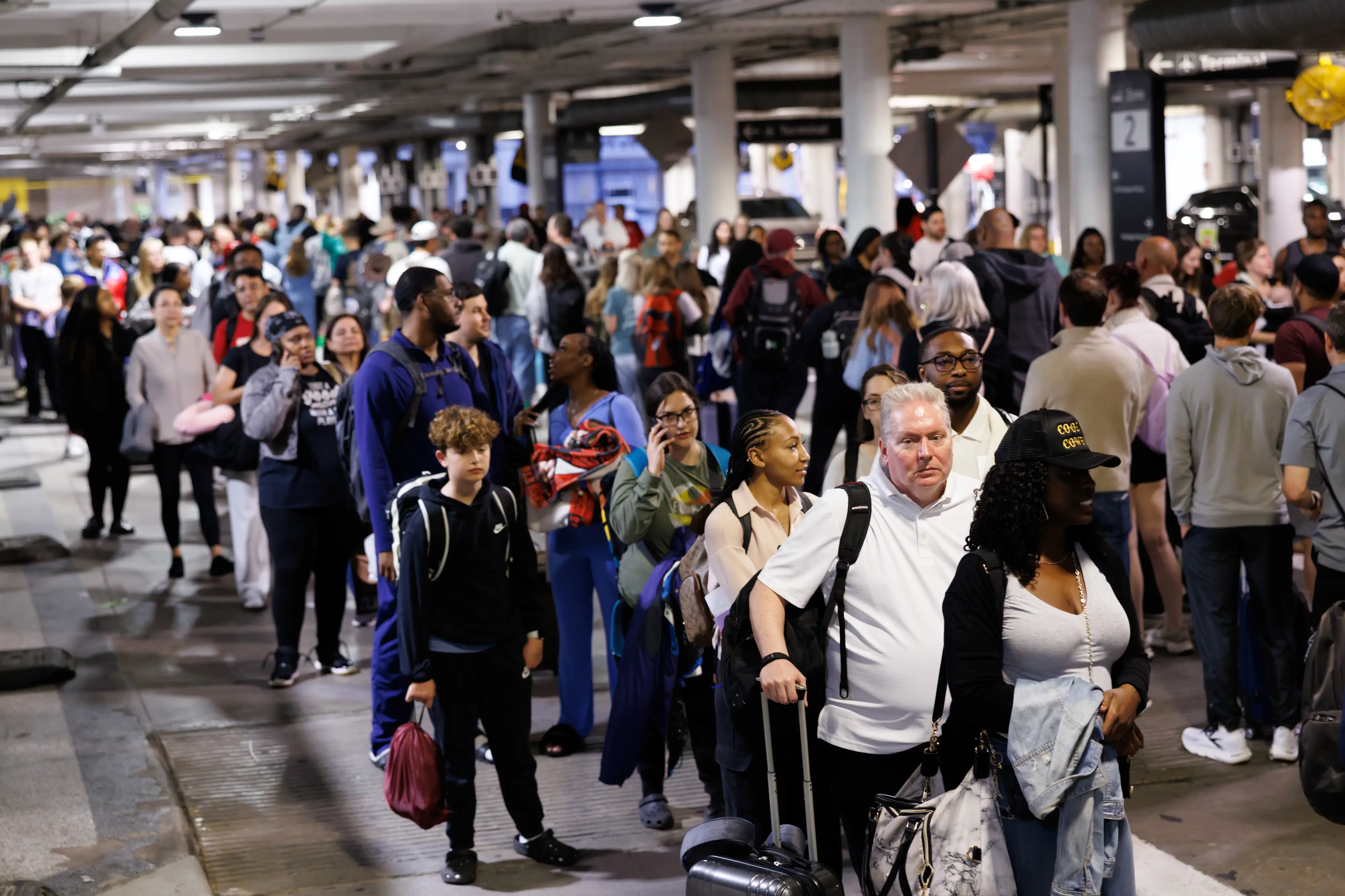 Travelers wait in line at a Transportation Security Administration (TSA) checkpoint.
