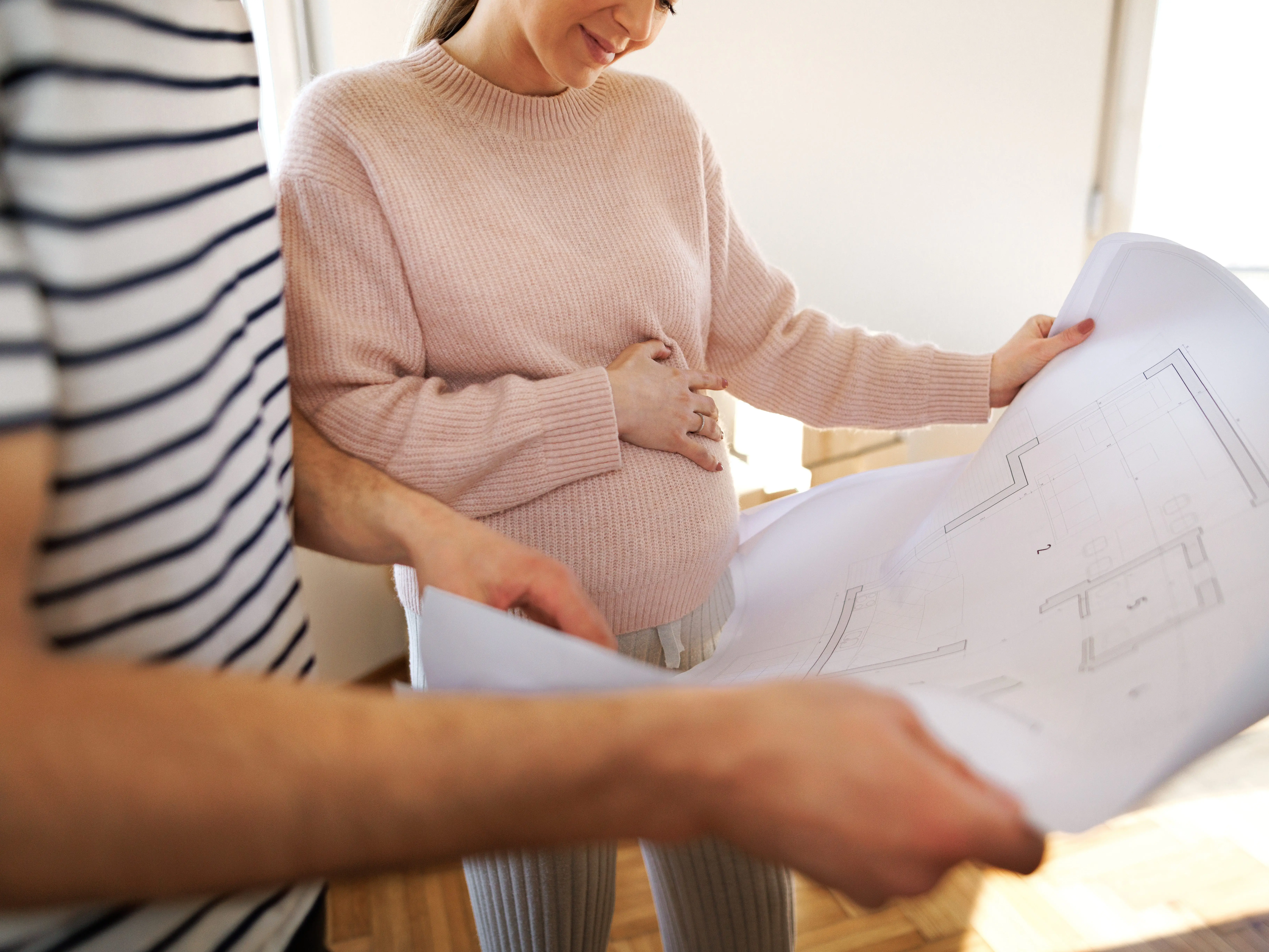 woman and her husband looking at blueprints