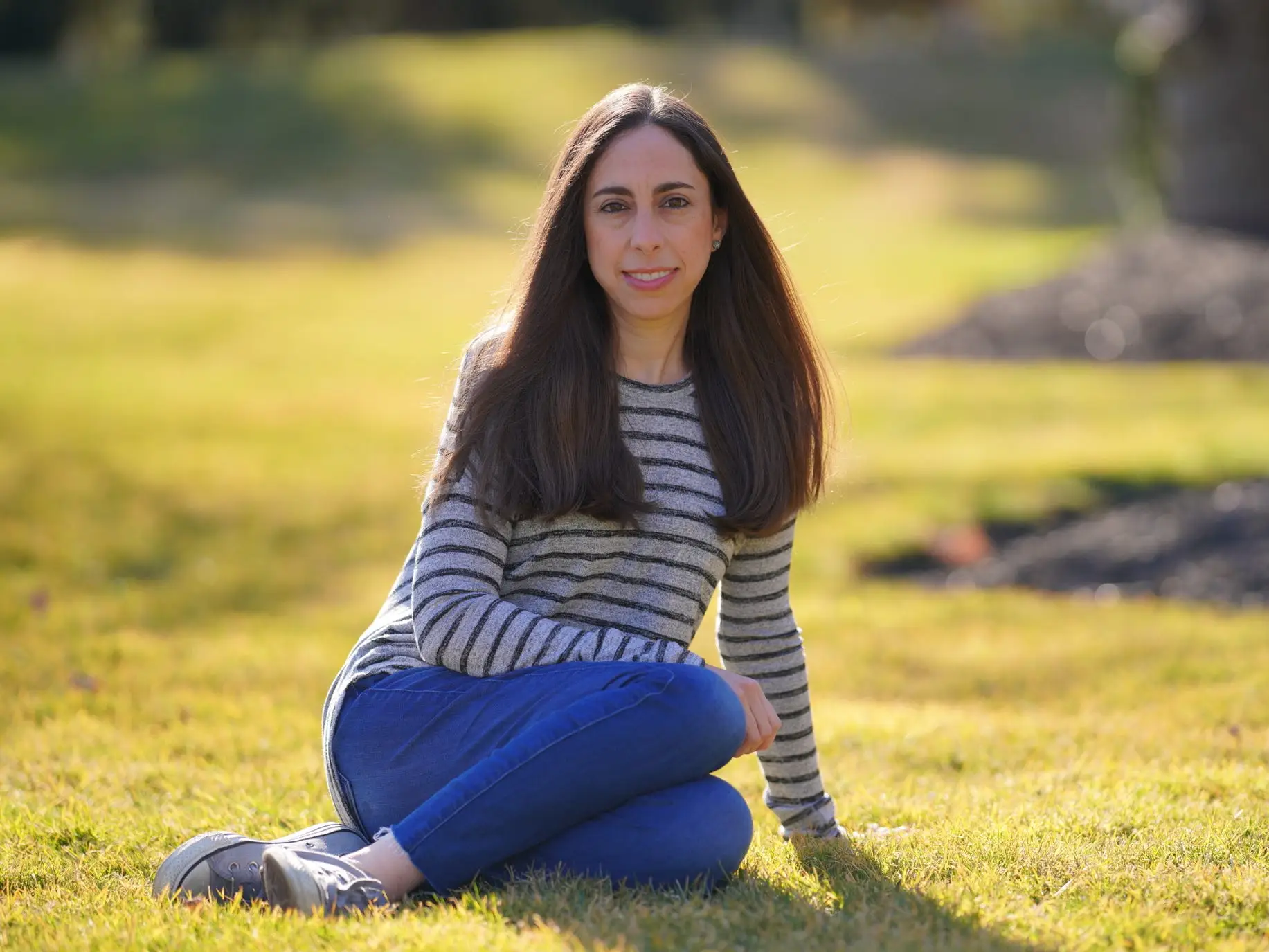 the author sitting on grass in the sun