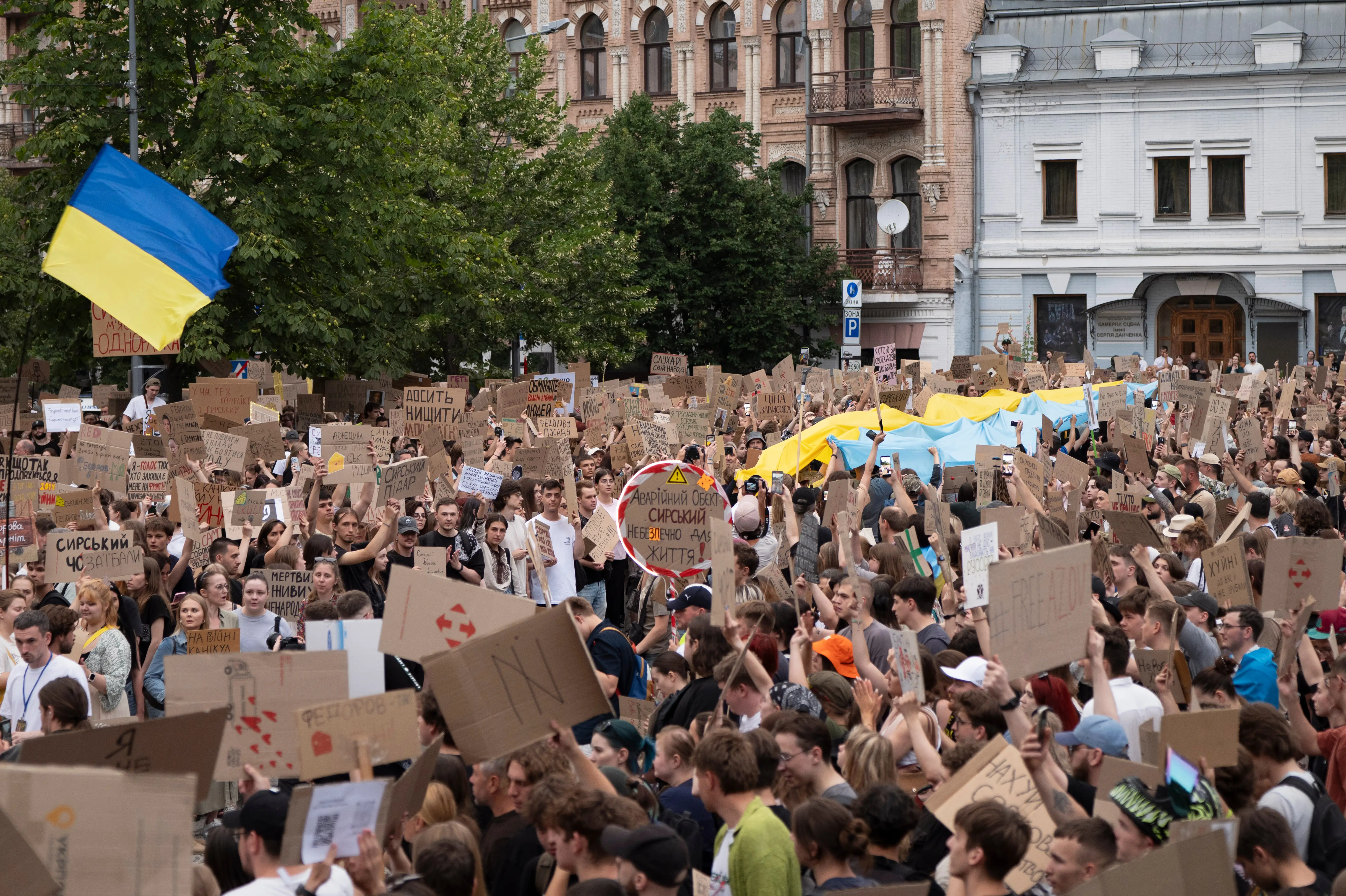 Hundreds gather in Kyiv with cardboard signs.