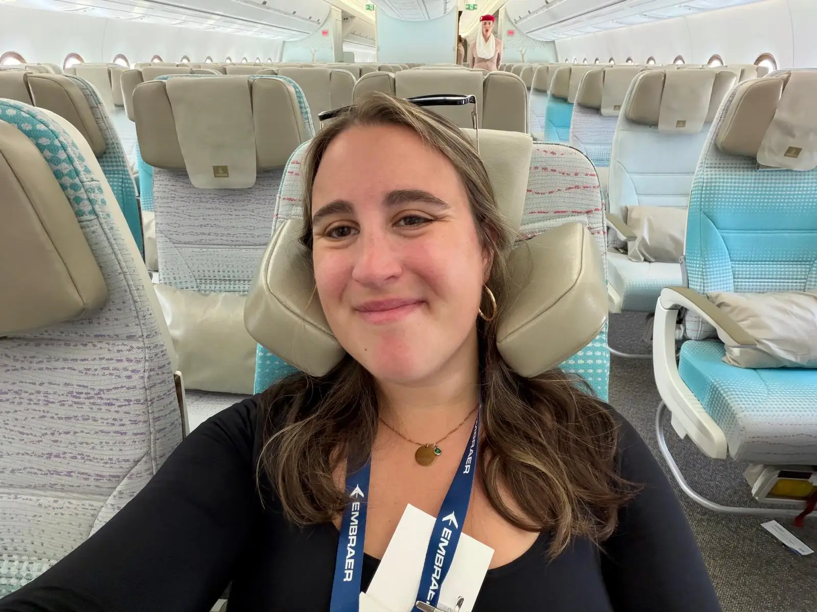 The author takes a selfie using the new headrest in an economy class seat on an Emirates Airbus A350-900