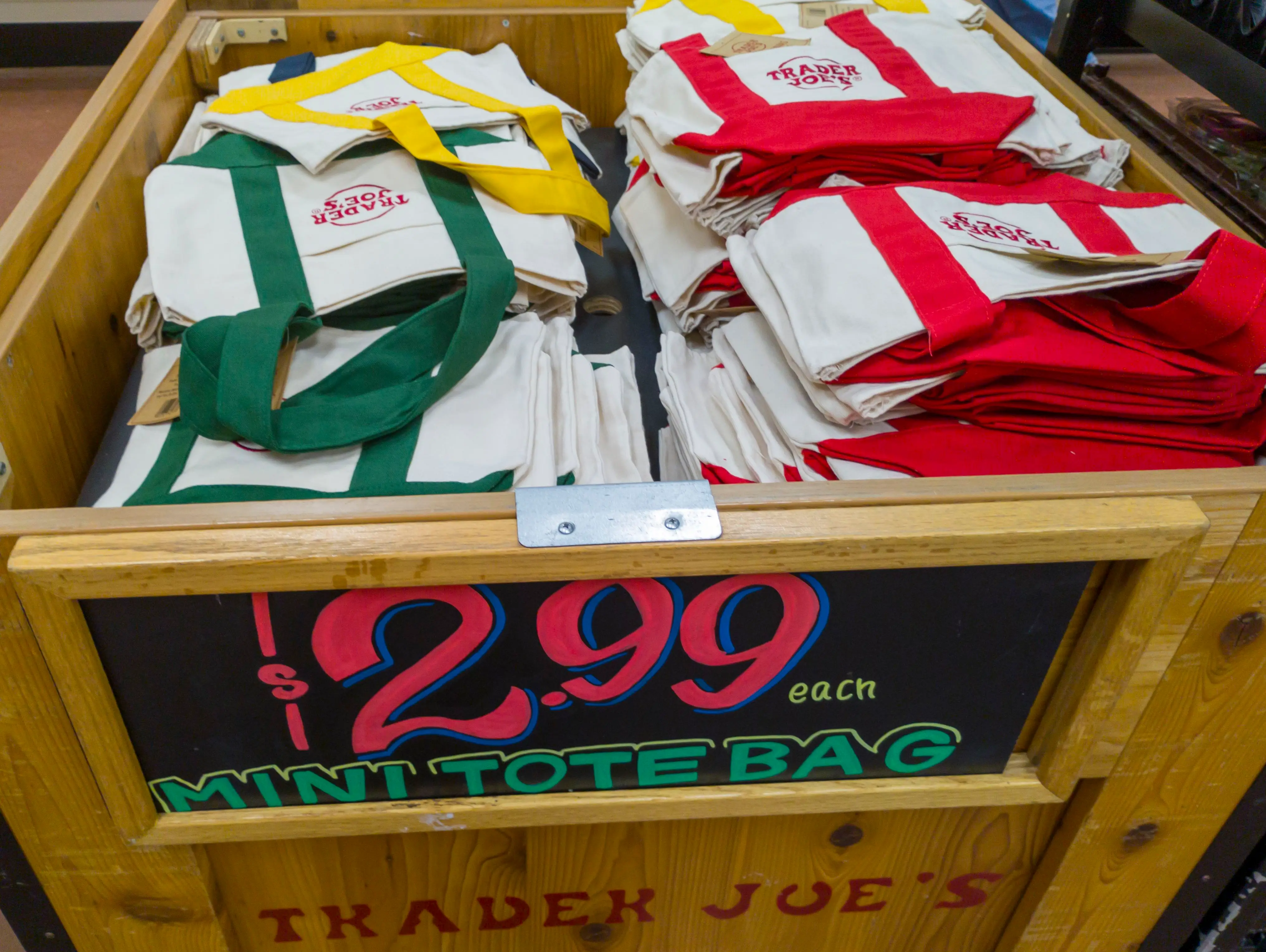 Bin full of canvas mini tote bags at Trader Joe's