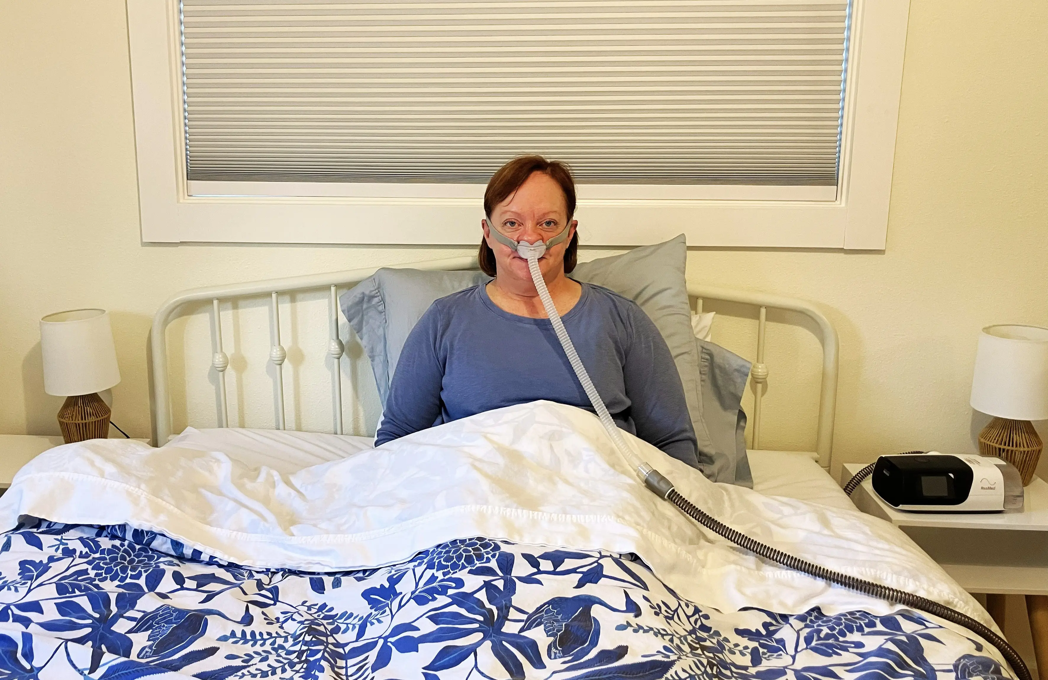the author in bed with her CPAP machine