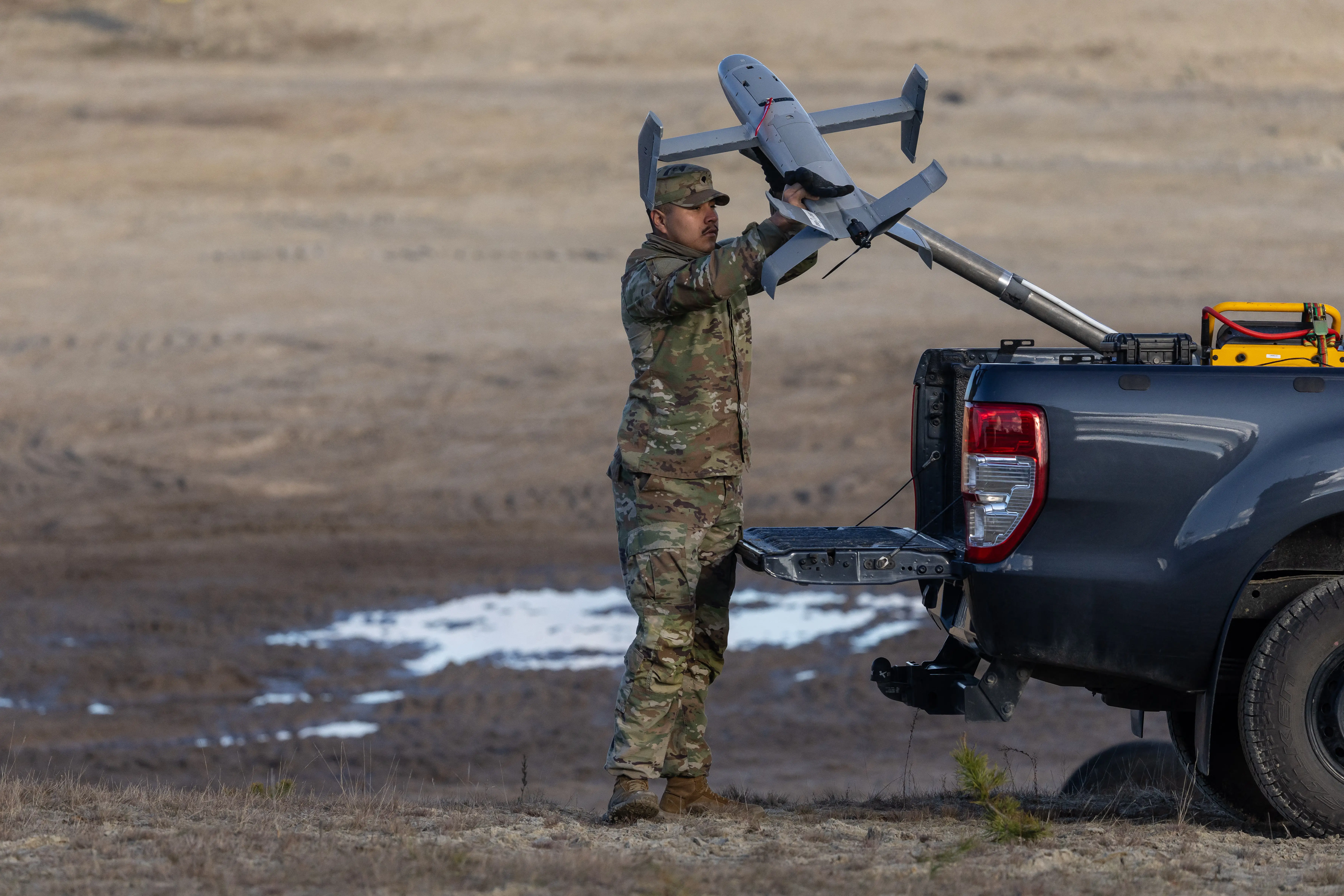 A US soldier operates an interception drone of the American Merops counter-drone system during tests at the Nowa Deba military training ground, south-eastern Poland, on November 18, 2025.