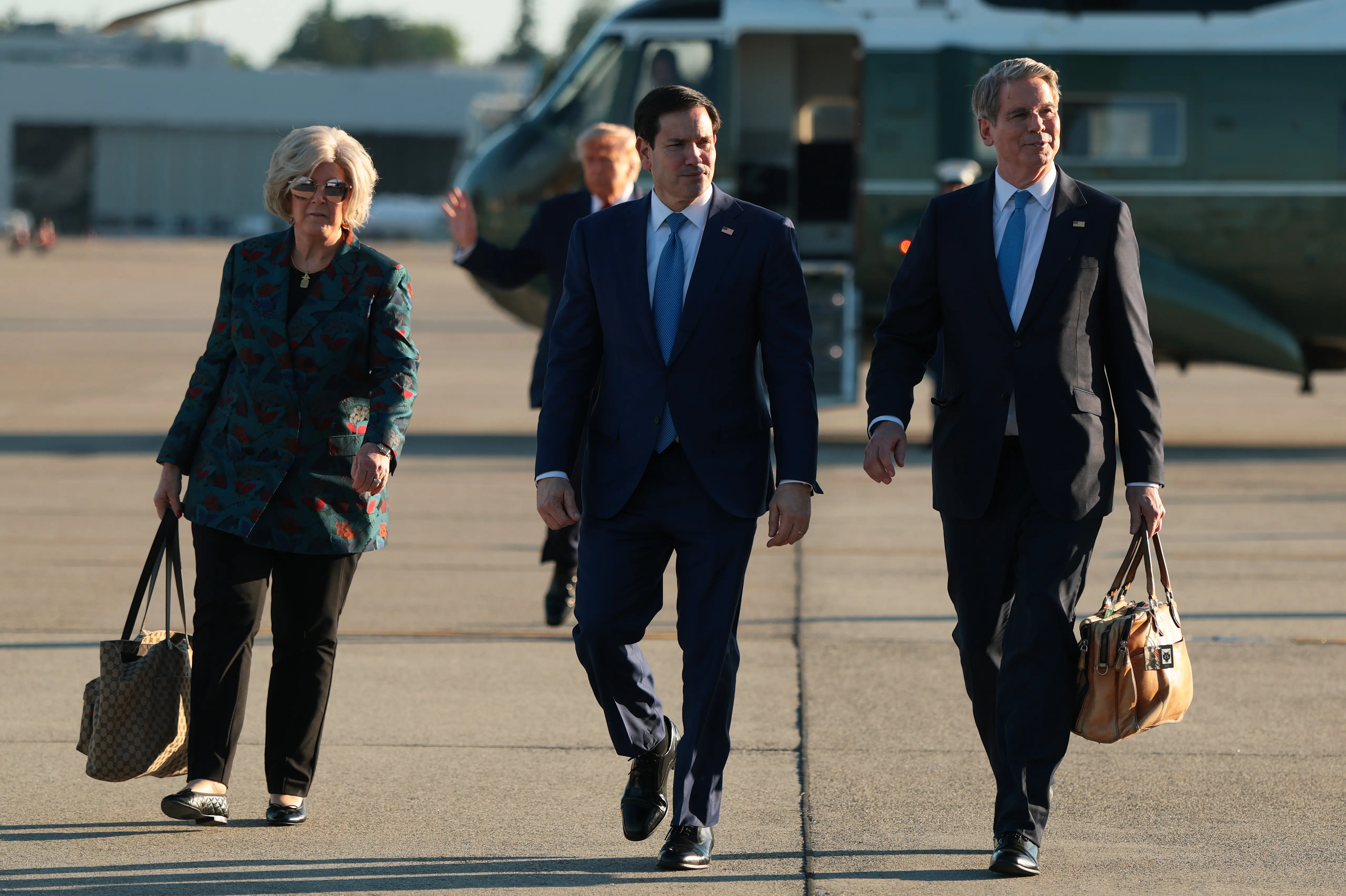 White House Chief of Staff Susie Wiles, U.S. Secretary of State Marco Rubio and U.S. Treasury Secretary Scott Bessent depart Marine One as they walk to board Air Force One at Geneva Airport.