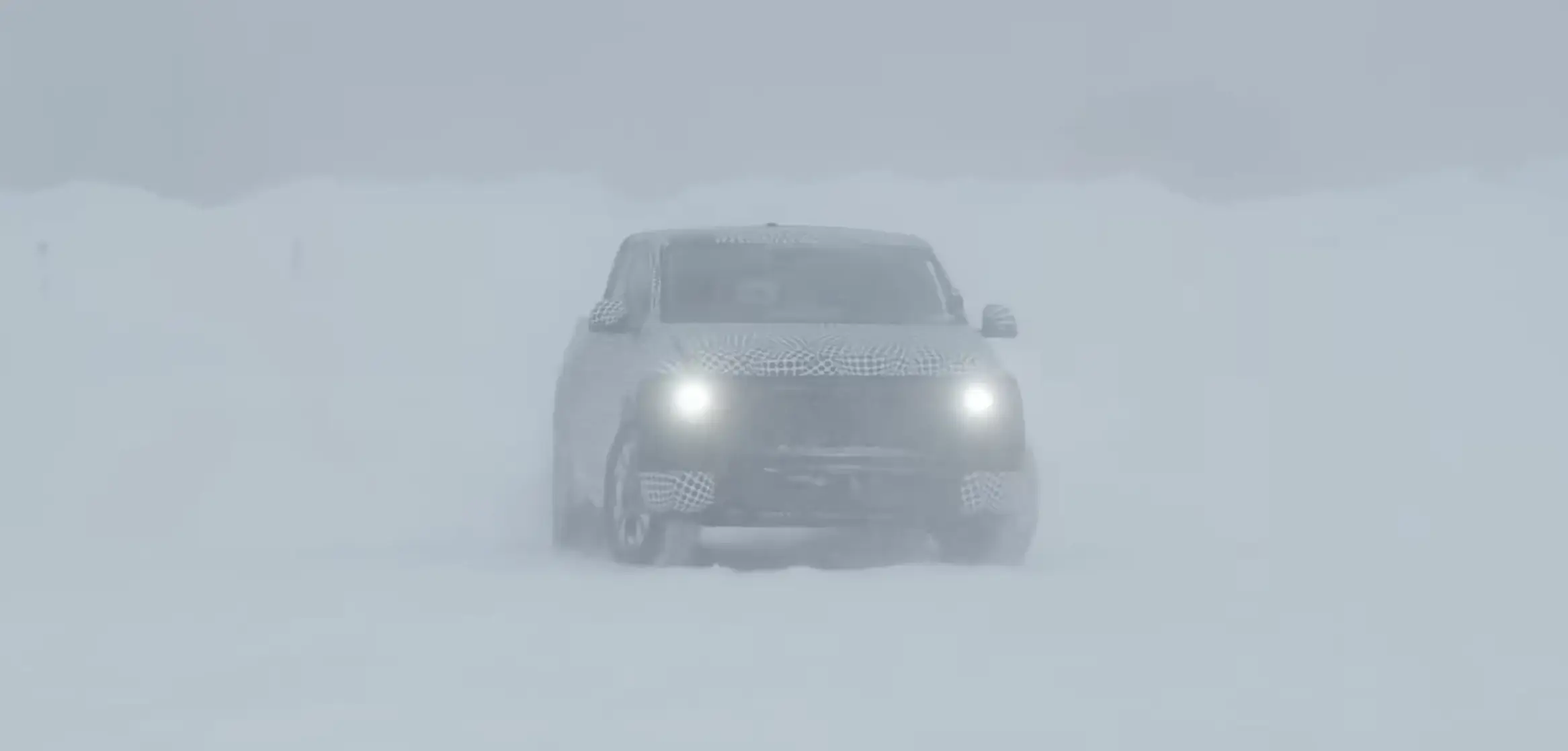 A Ford electric pickup truck tests on a snowy track.
