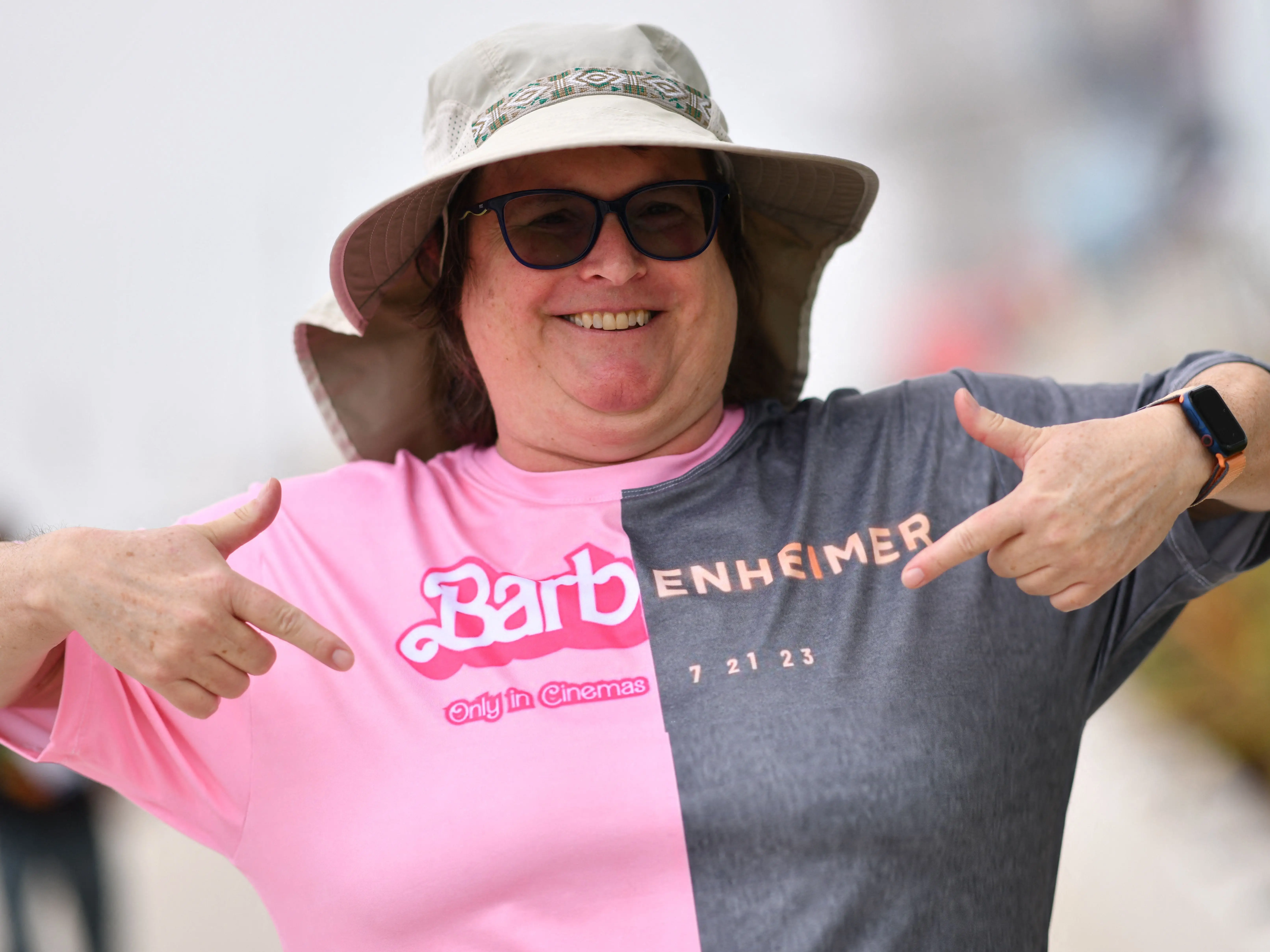An attendee points at her Barbenheimer shirt outside the convention center during San Diego Comic-Con International in San Diego, California, on July 20, 2023.