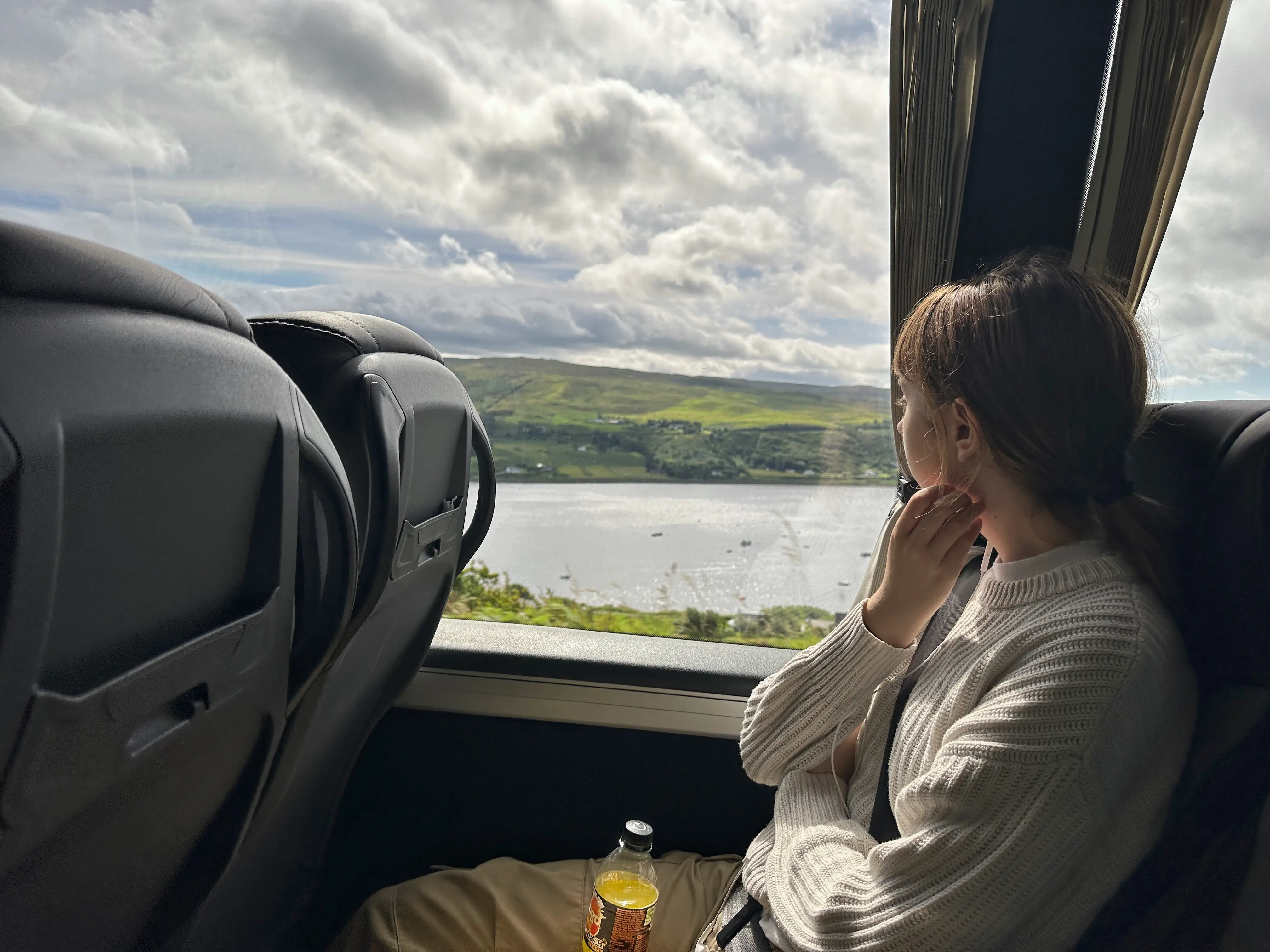 The author's daughter looks out the window while traveling through Scotland.
