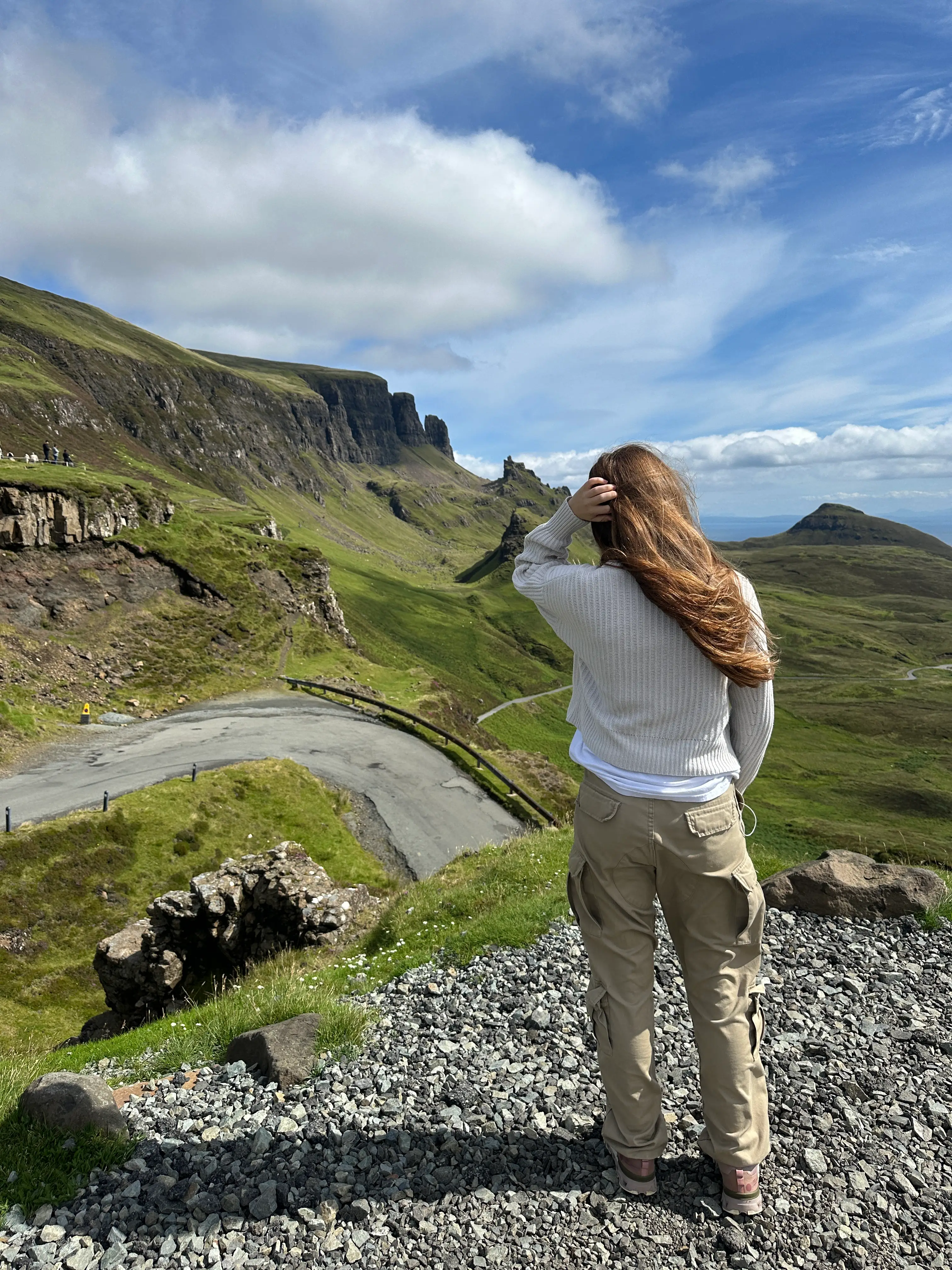 The author's daughter stands on a cliff.