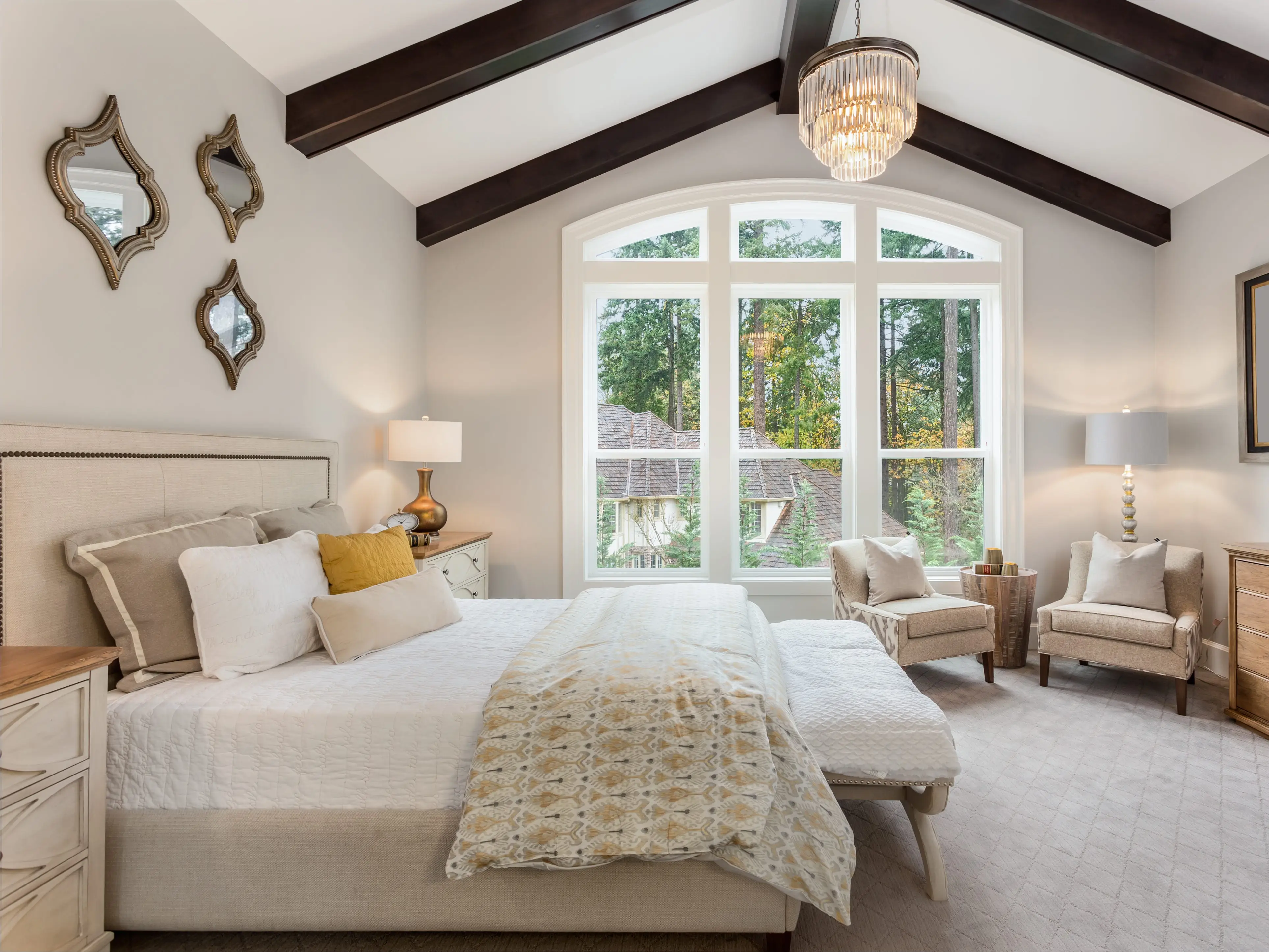 A bedroom with a chandelier.
