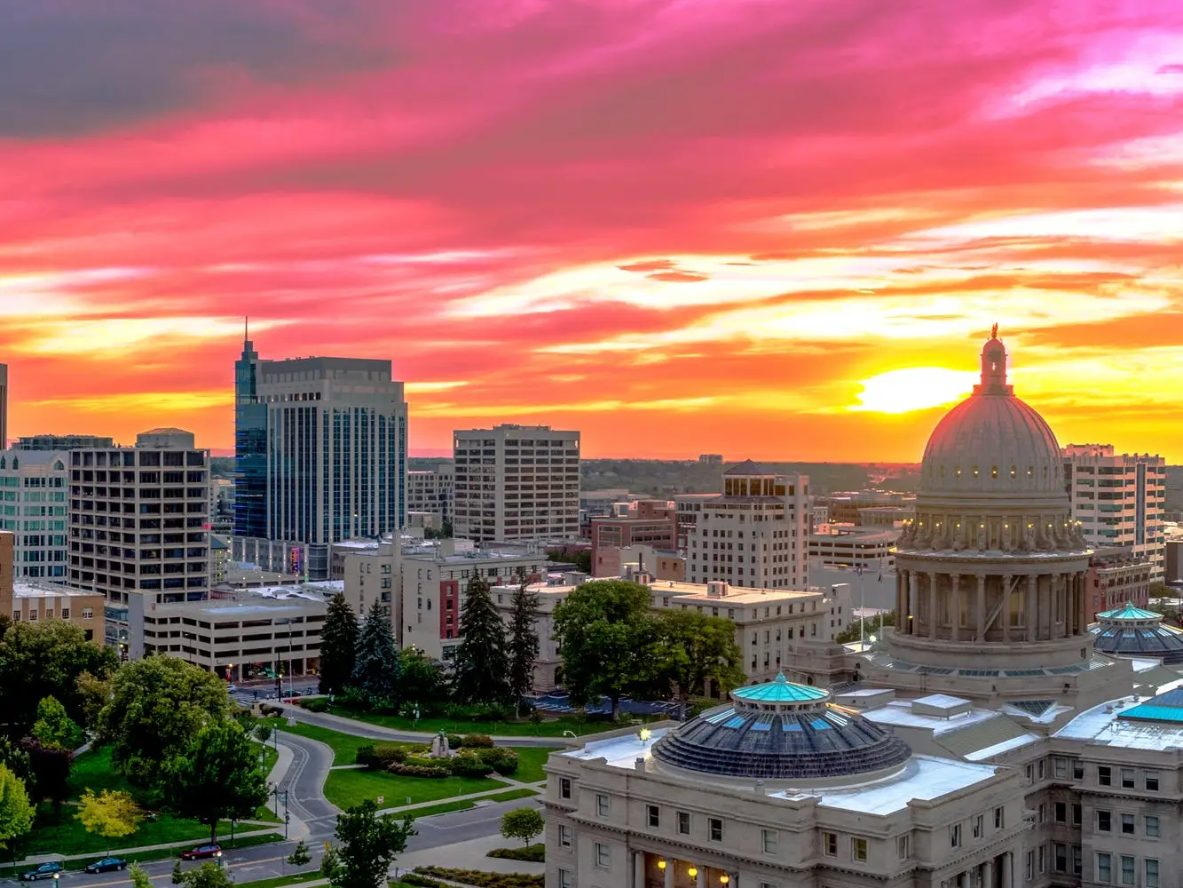 State capitol building next to buildings in Boise, Idaho.