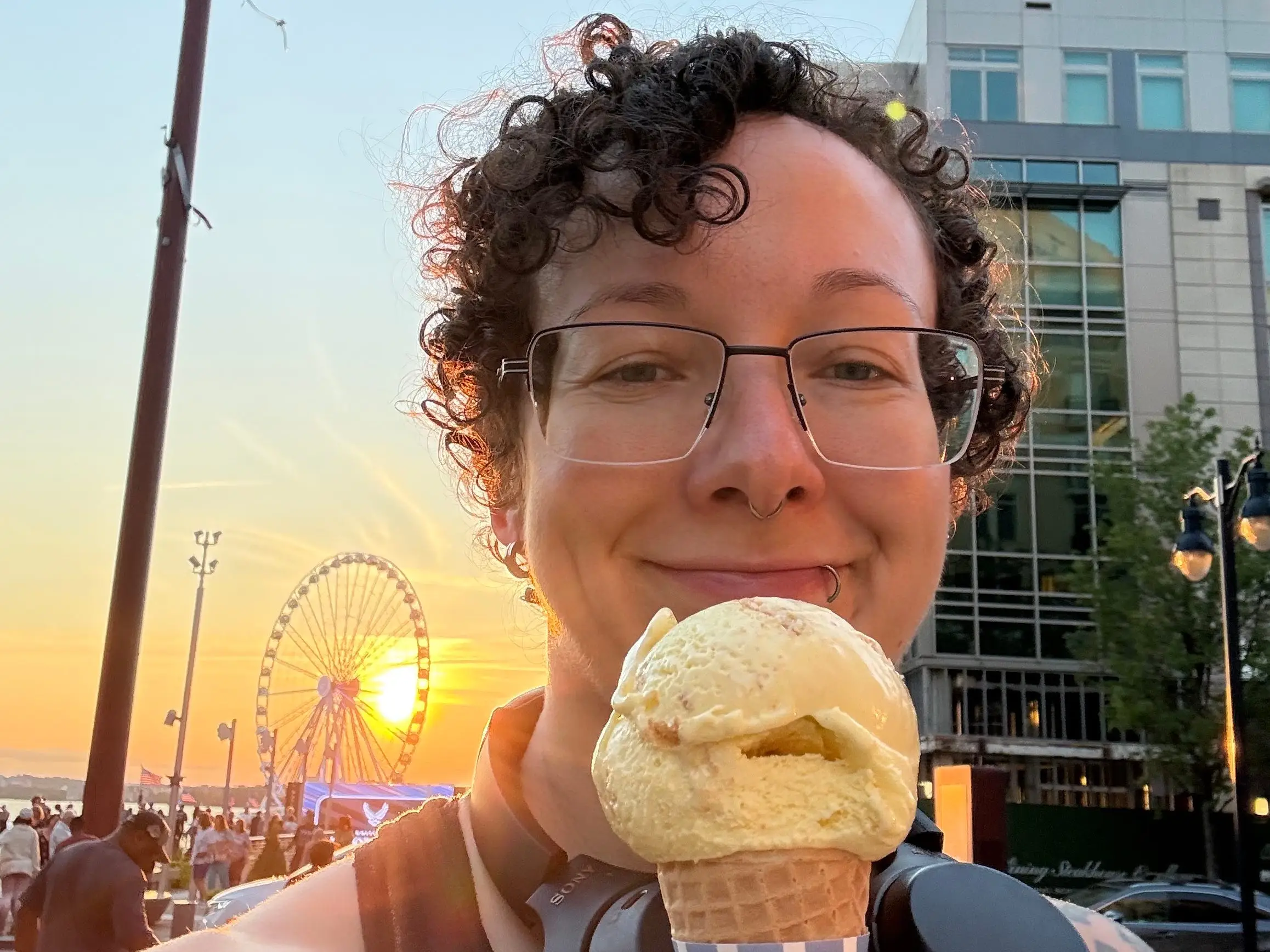 A smiling journalist with an ice cream cone