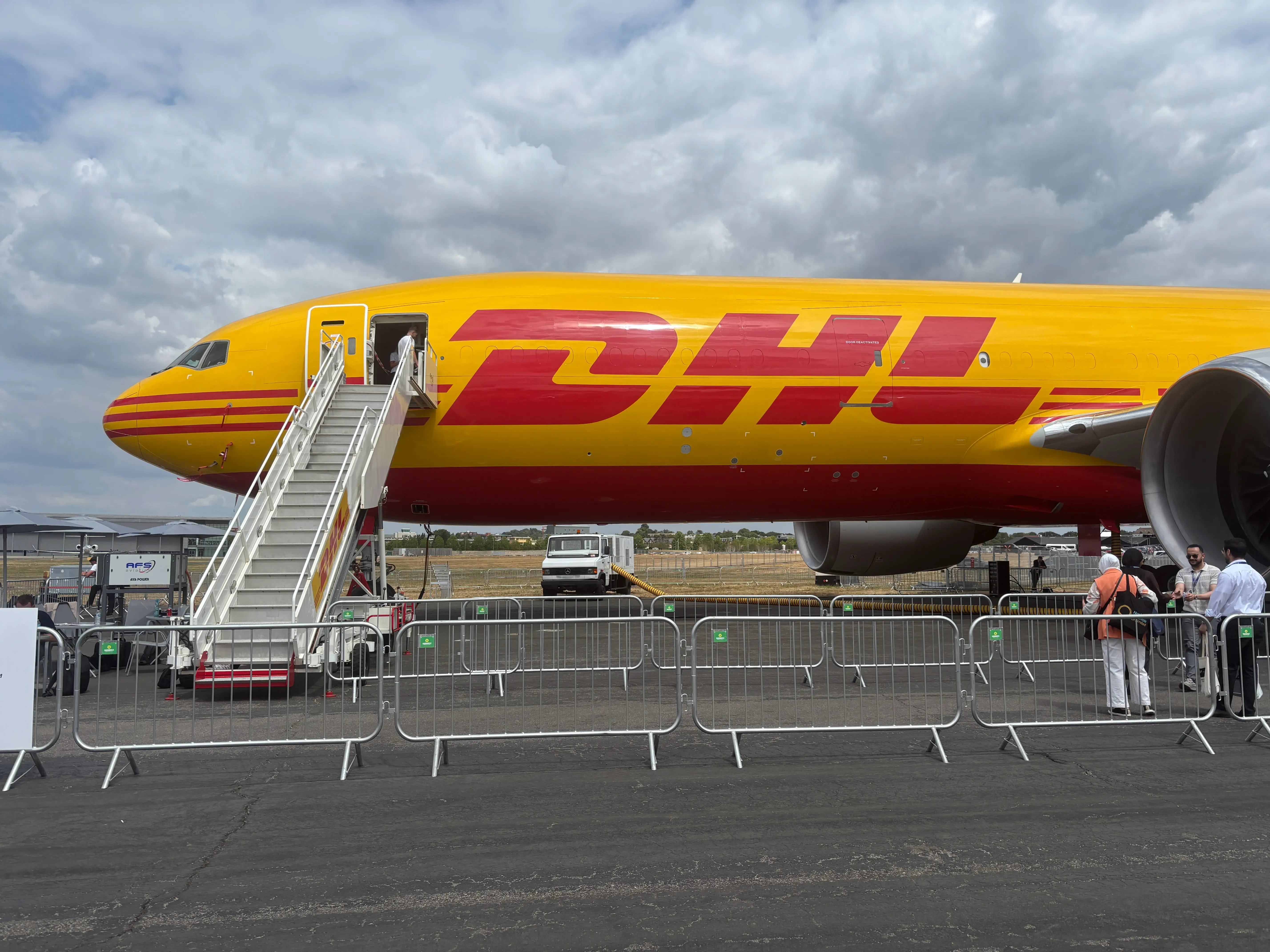 A side view of a DHL Boeing 777 on display at the 2026 Farnborough Airshow
