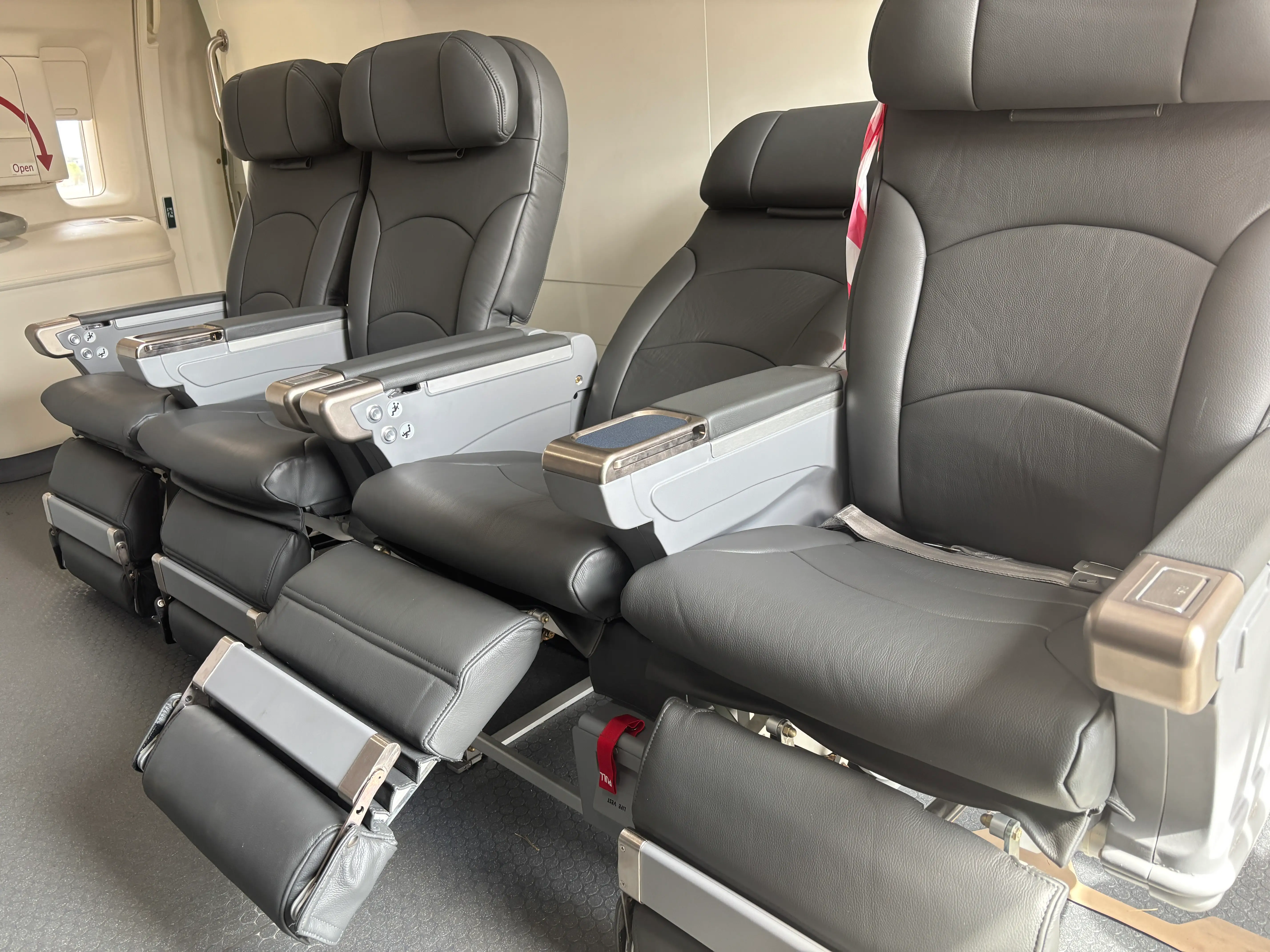 Four seats, one of which is reclined, on board a DHL Boeing 777