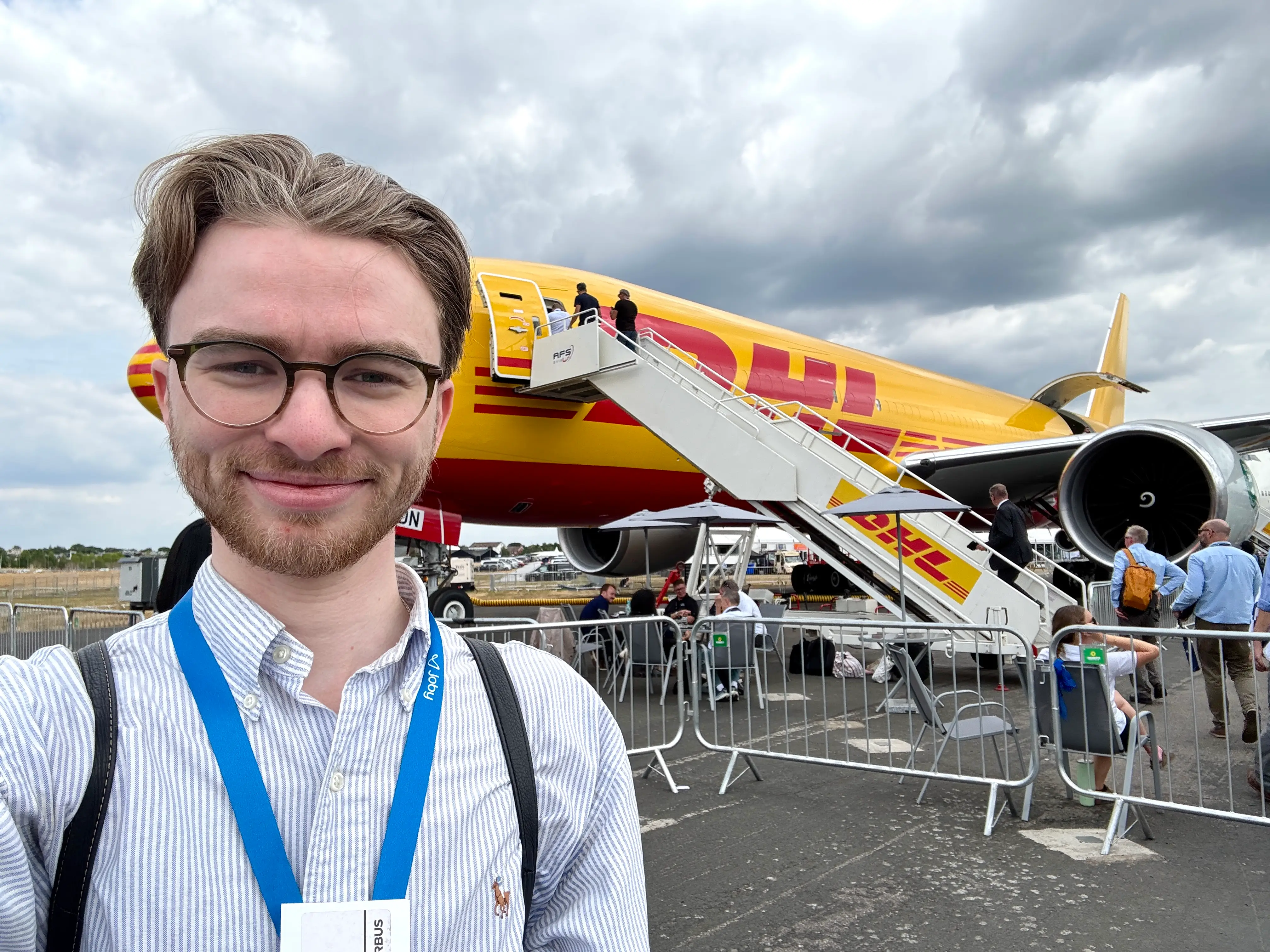 The author takes a selfie in front of a DHL Boeing 777 at the 2026 Farnborough Airshow